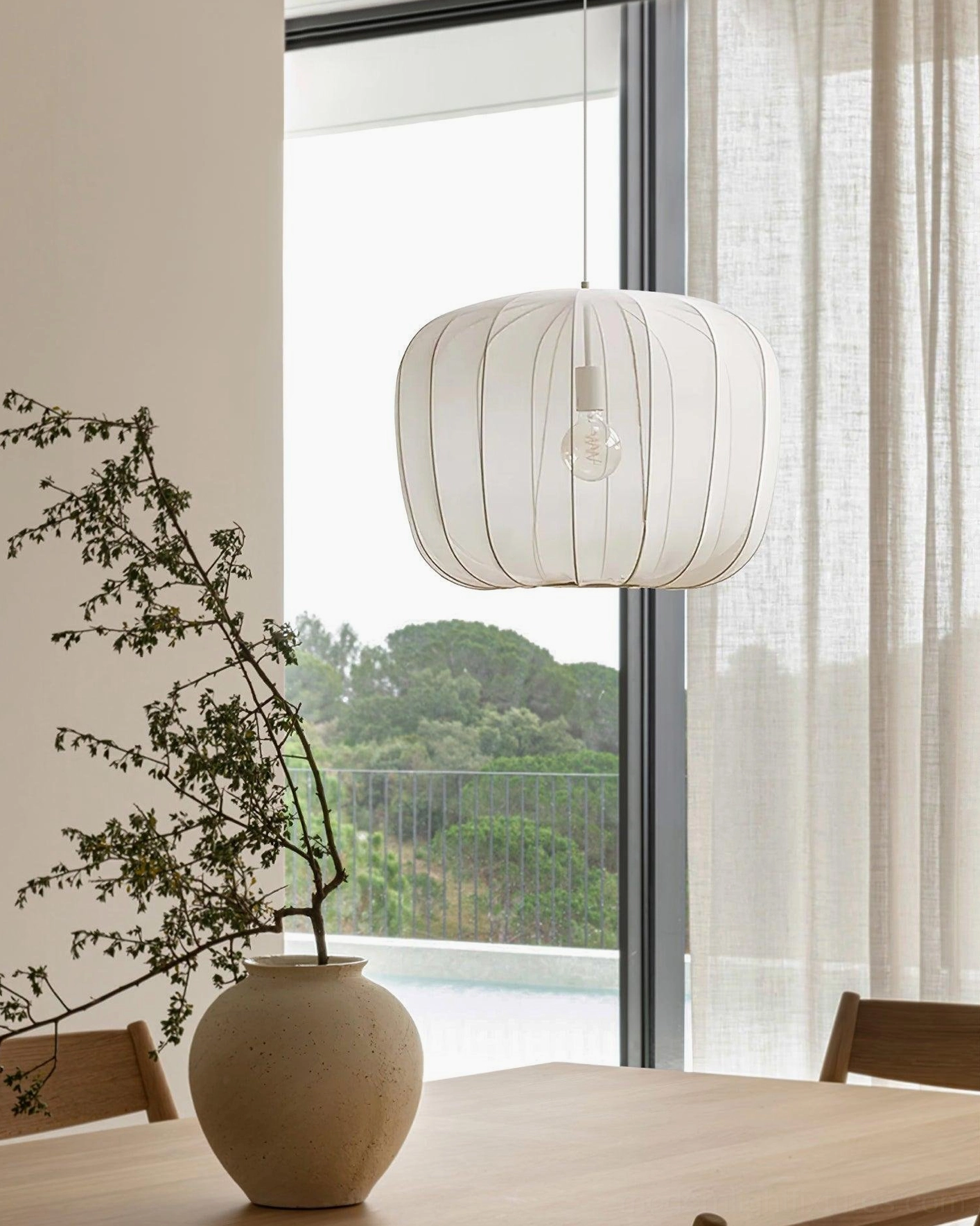 White Nevola mesh pendant light near window, minimalist modern dining room home interior design