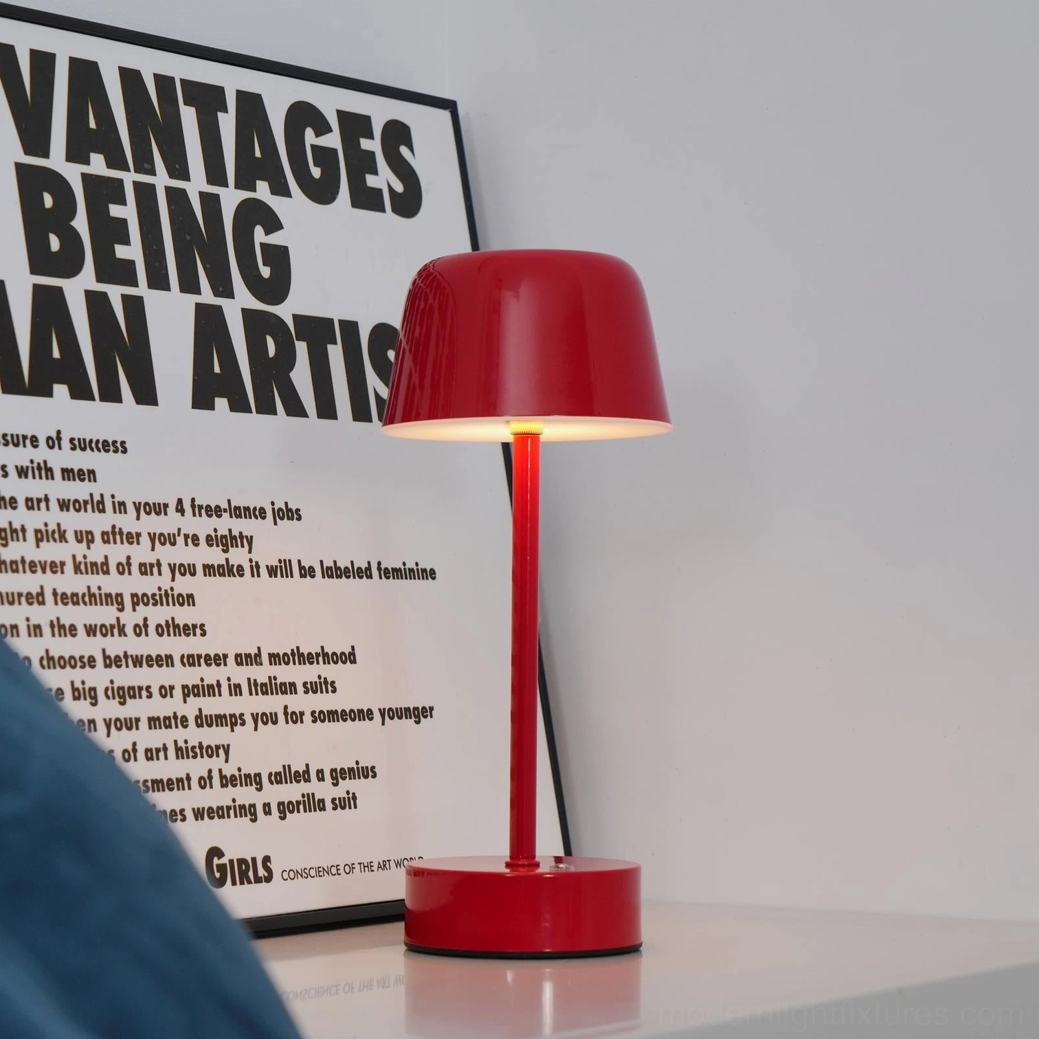 Red rechargeable LED table lamp displayed on side table beside art poster home decor