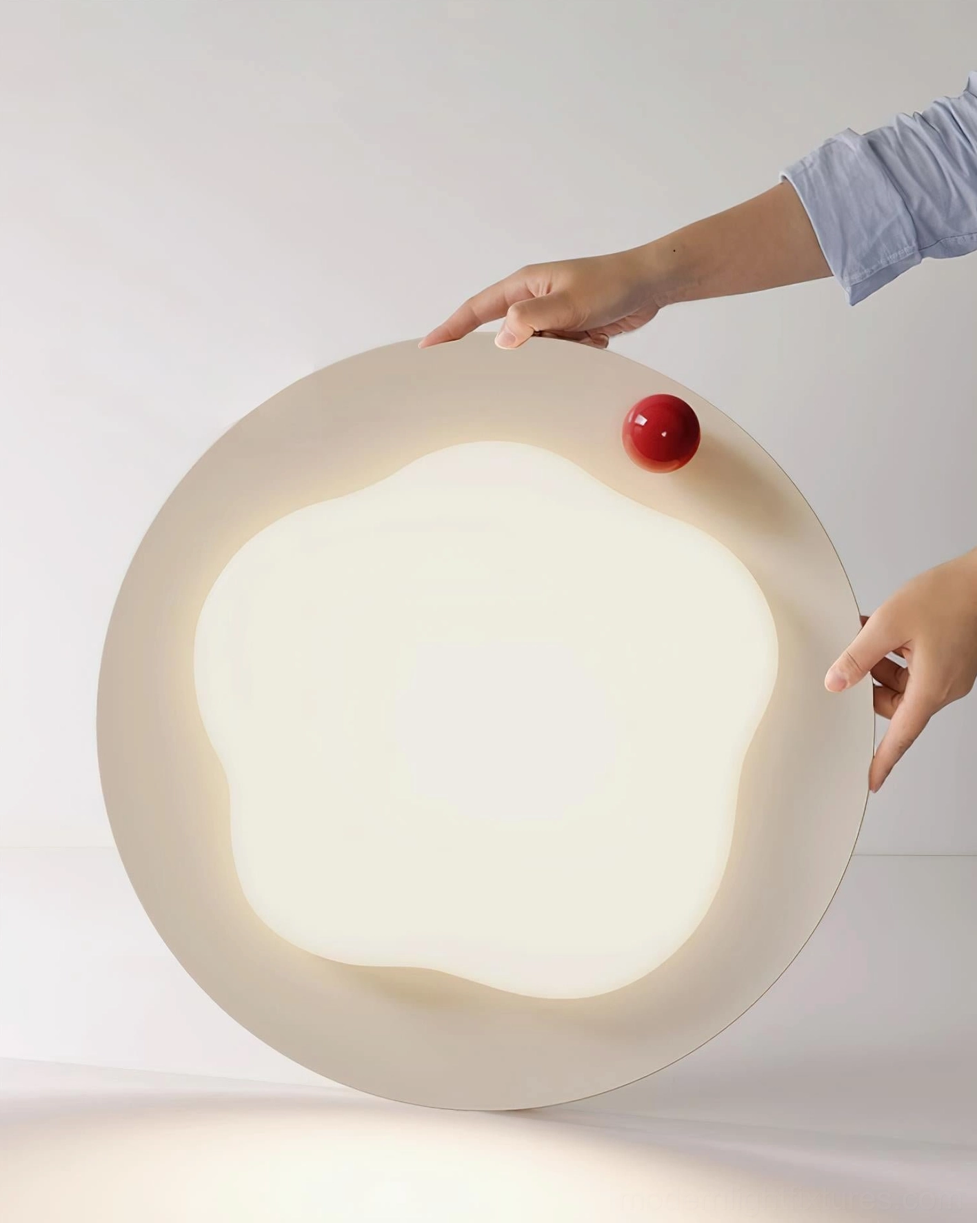 Niera cloud ceiling light held up display showing creamy frame, red accent ball, and frosted acrylic panel side view