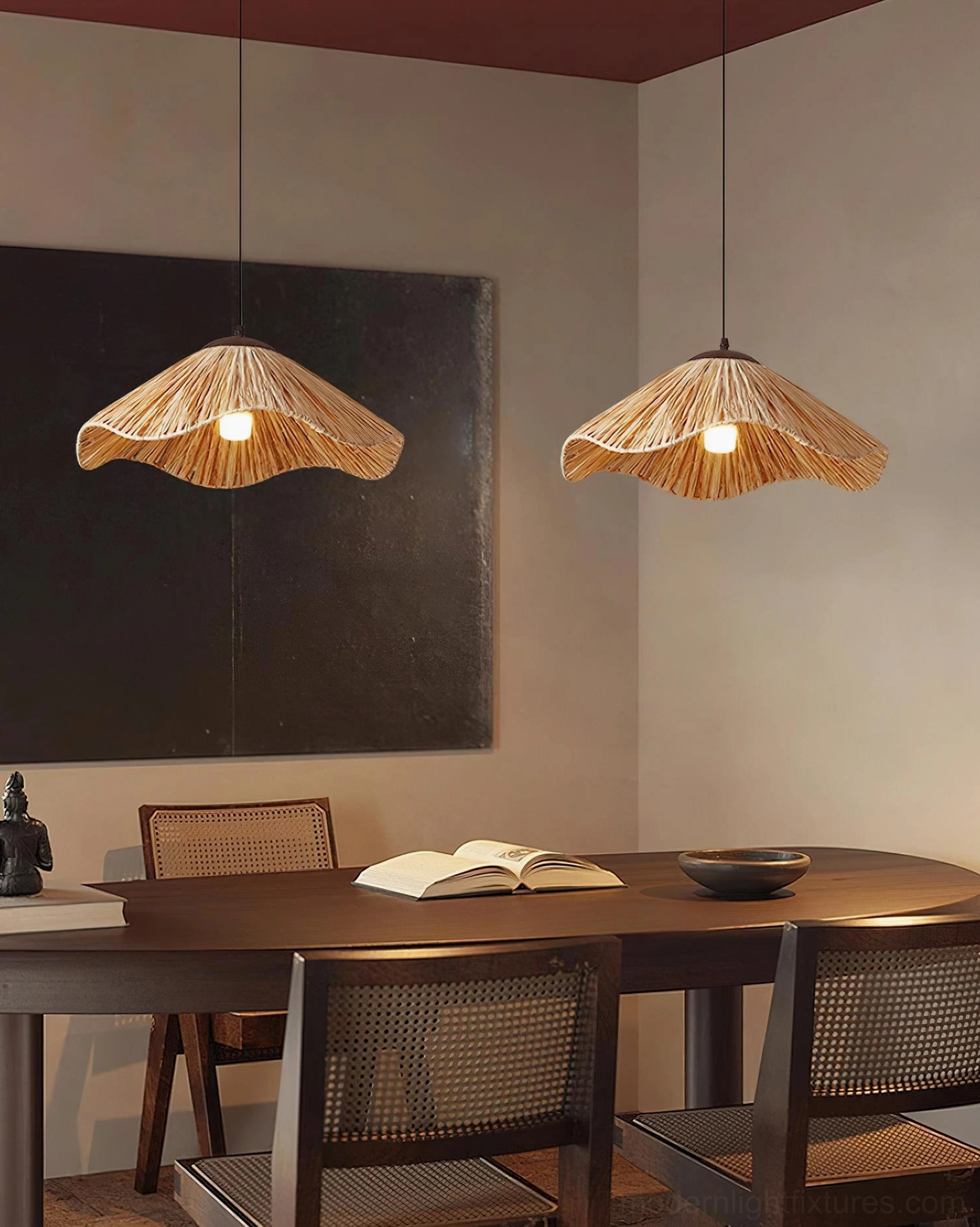 Two natural rattan wavy pendant lamps suspended in rustic dining room with wooden table and bohemian decor