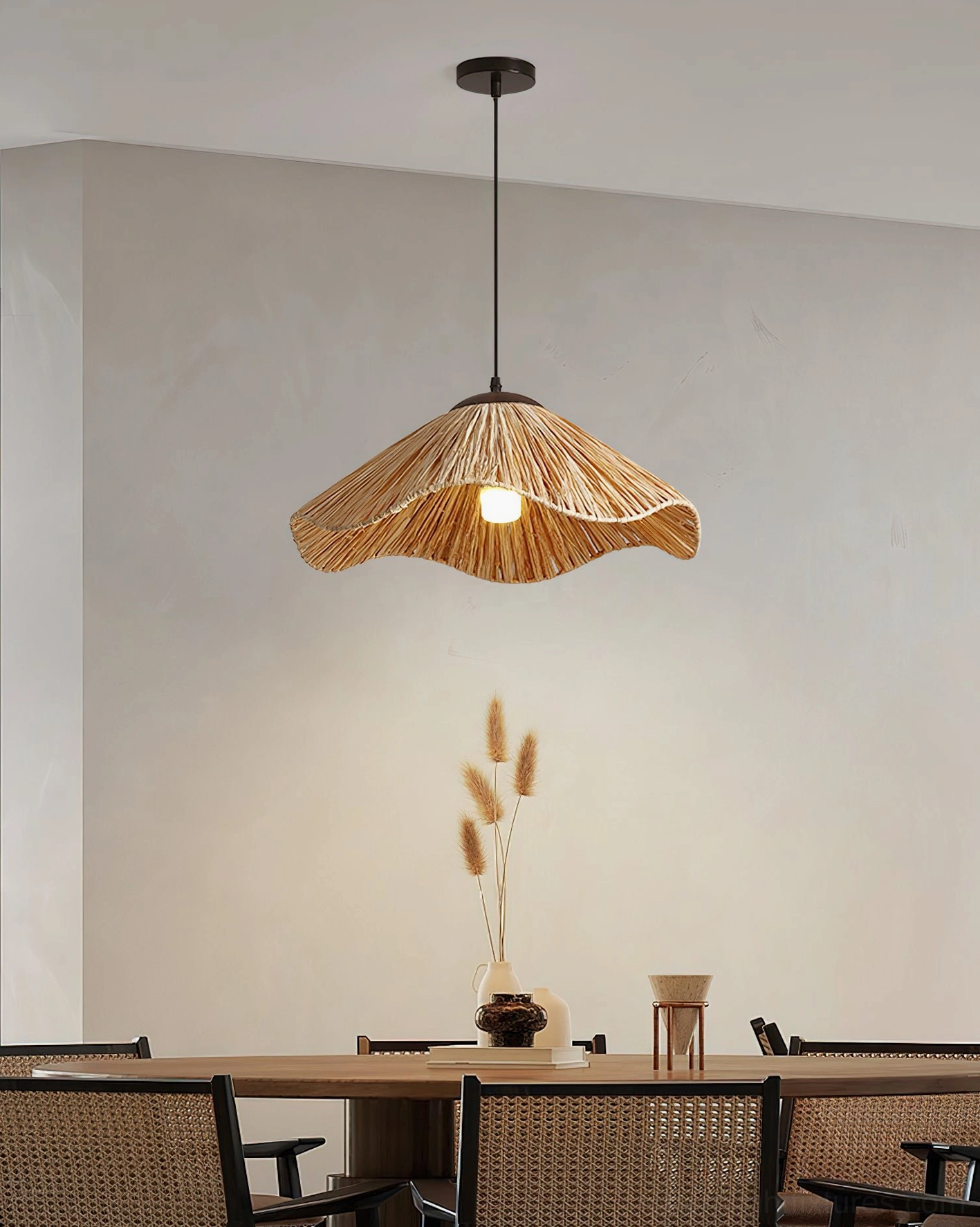 Natural rattan pendant light creating warm ambient glow in casual dining space with minimalist decor