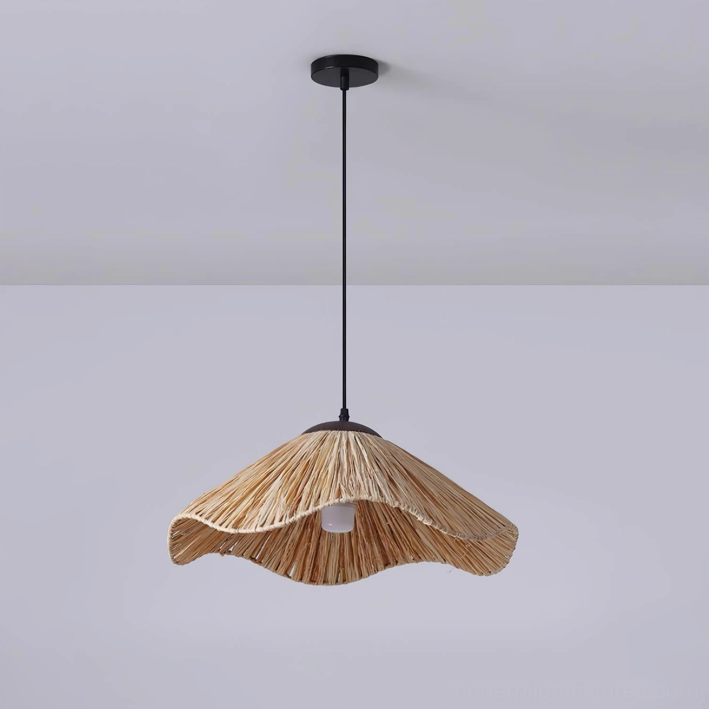Front low-angle view of natural rattan pendant light showing wavy silhouette with exposed bulb and black hardware