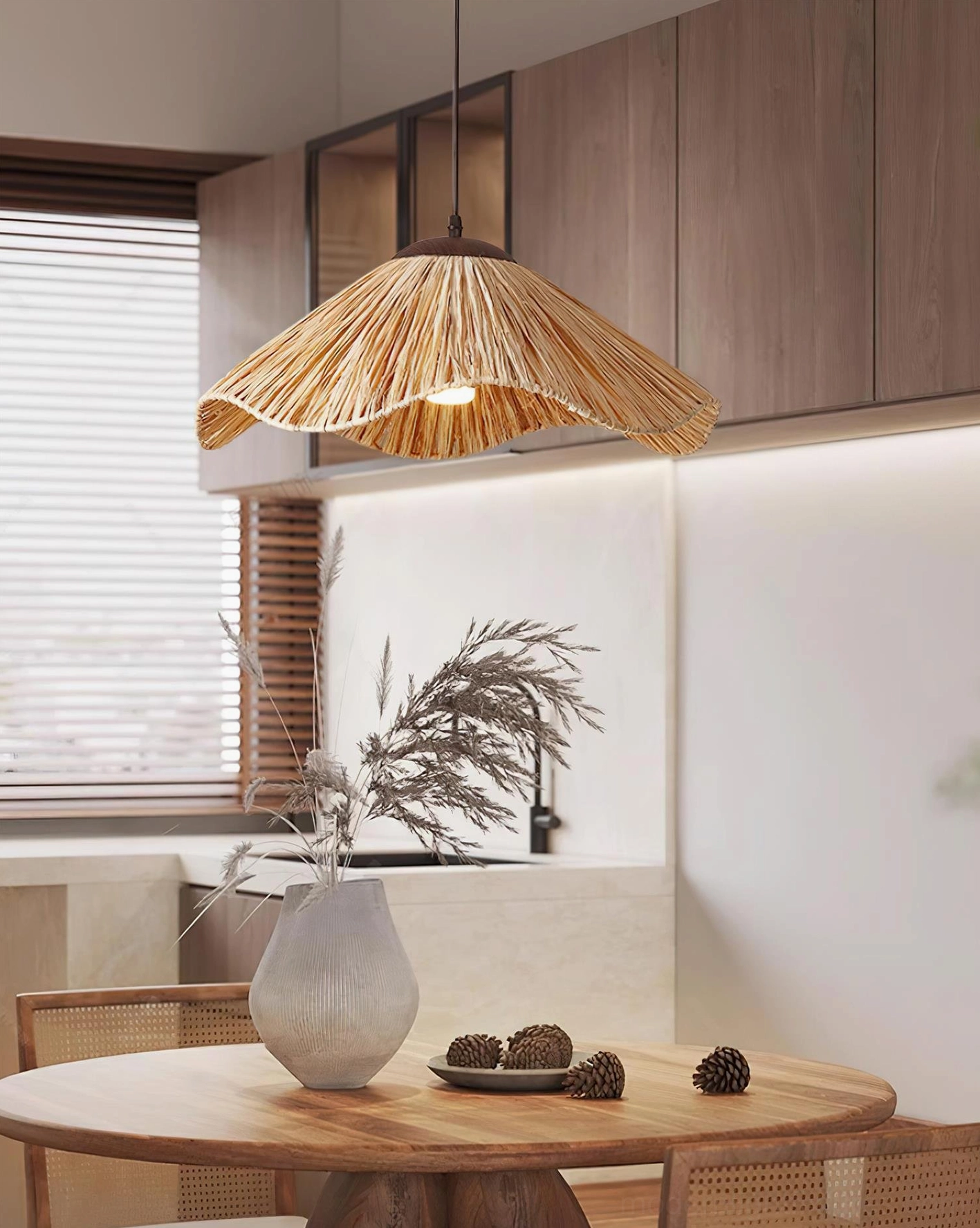 Nikita woven rattan pendant lamp illuminating modern rustic kitchen-dining area with wood cabinetry