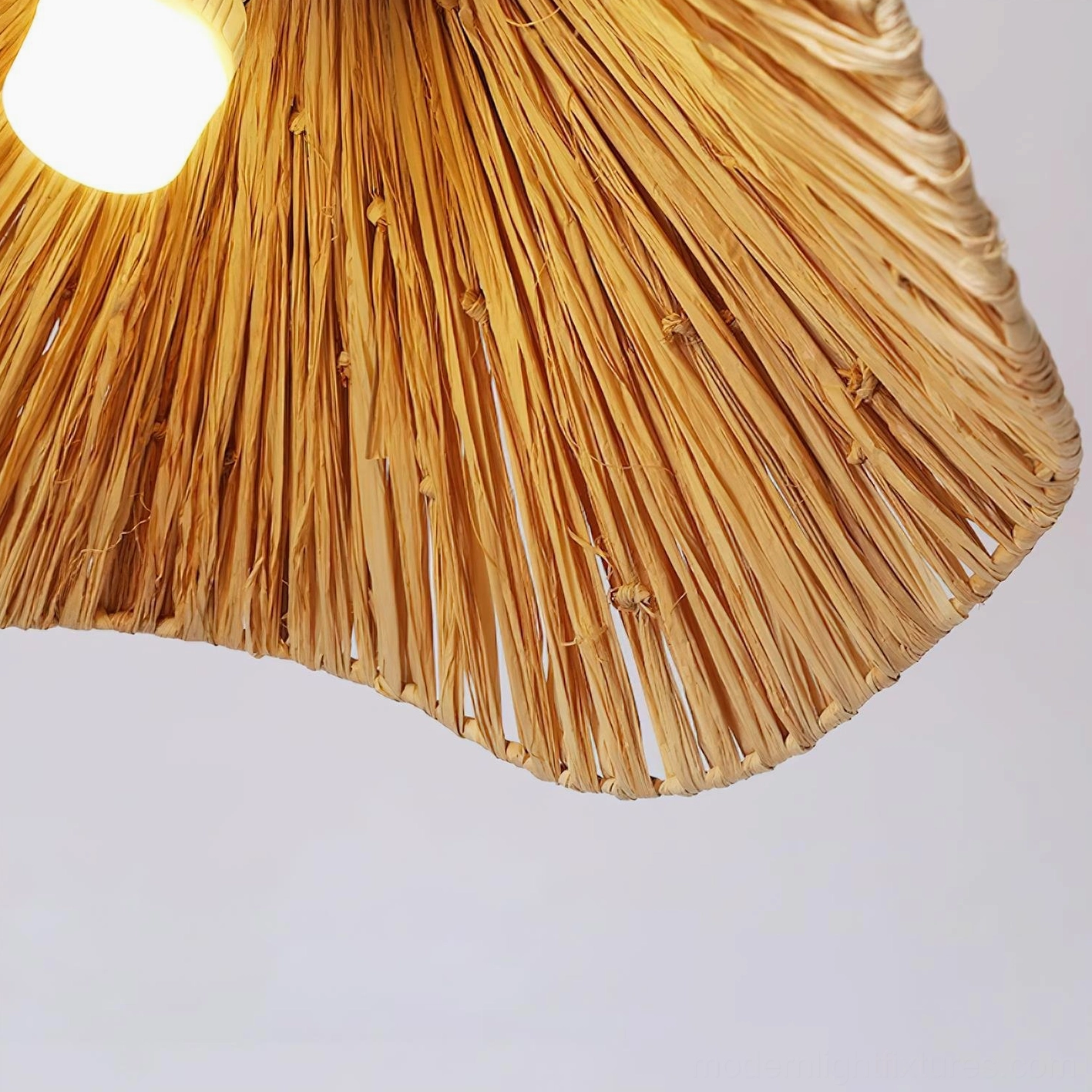 Natural rattan organic wave pendant light in minimalist bohemian home decor setting with neutral palette