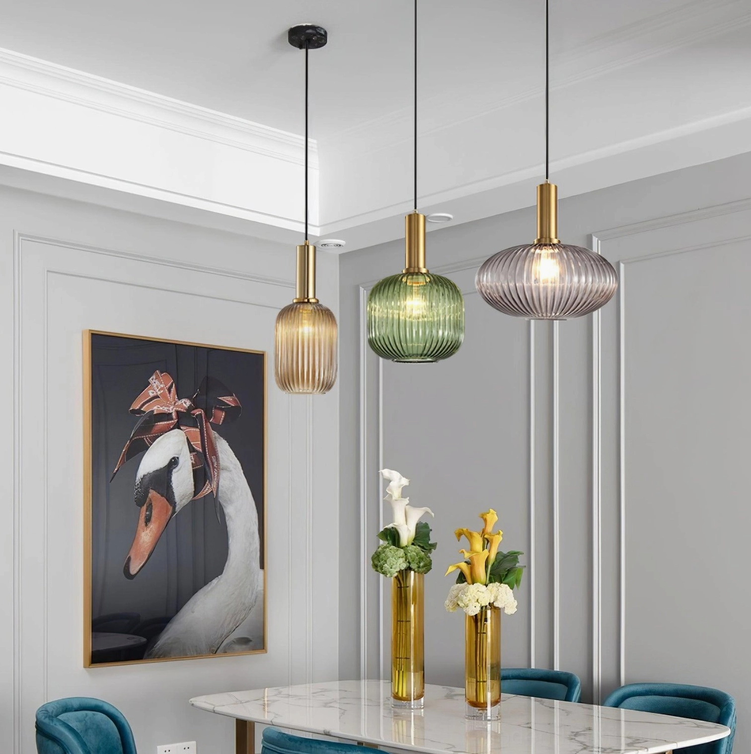 Contemporary dining room with three ribbed glass pendant lights suspended above marble dining table in modern home interior