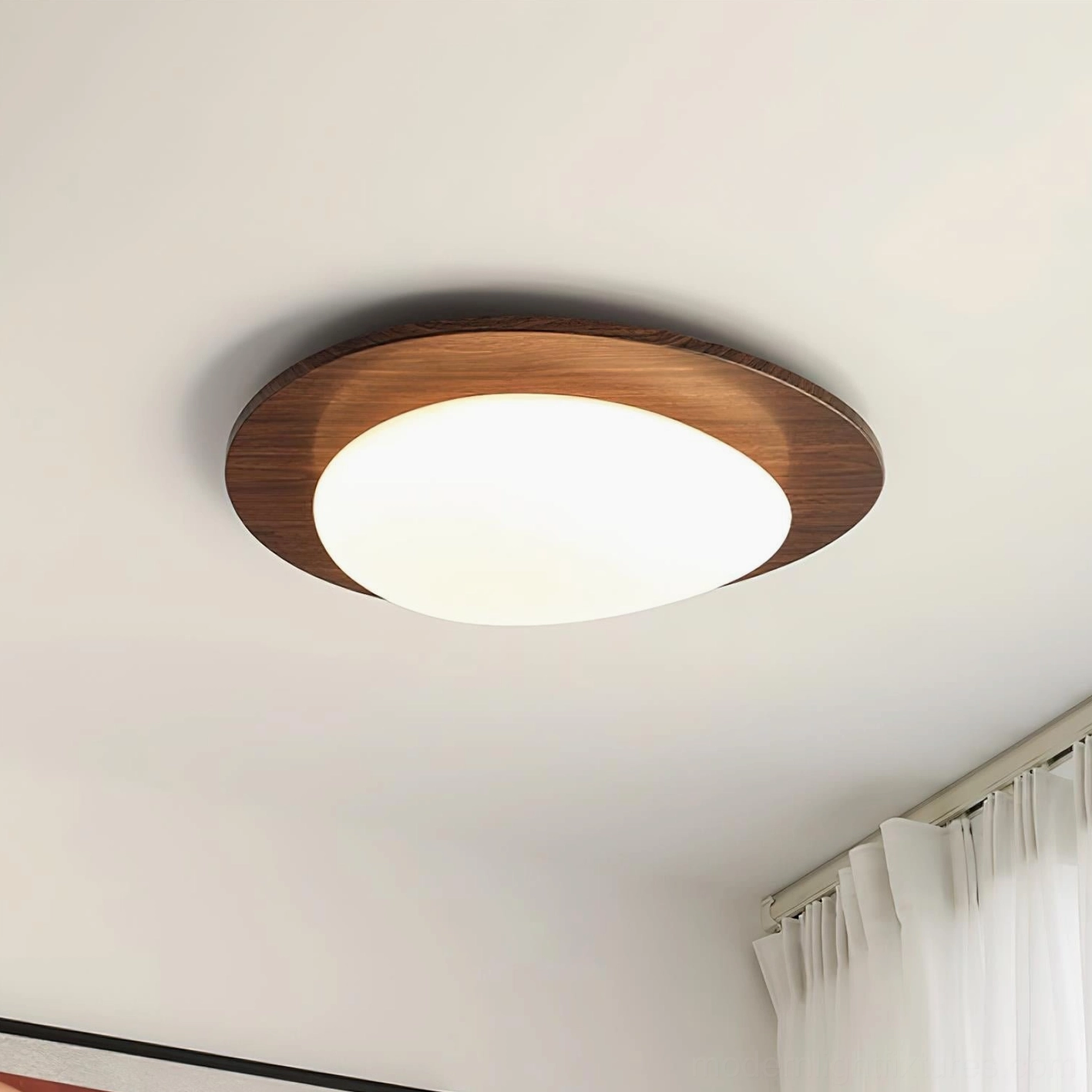 Niseko modern oval ceiling fixture installed on bedroom ceiling, emitting warm white 3000K ambient light with soft glow
