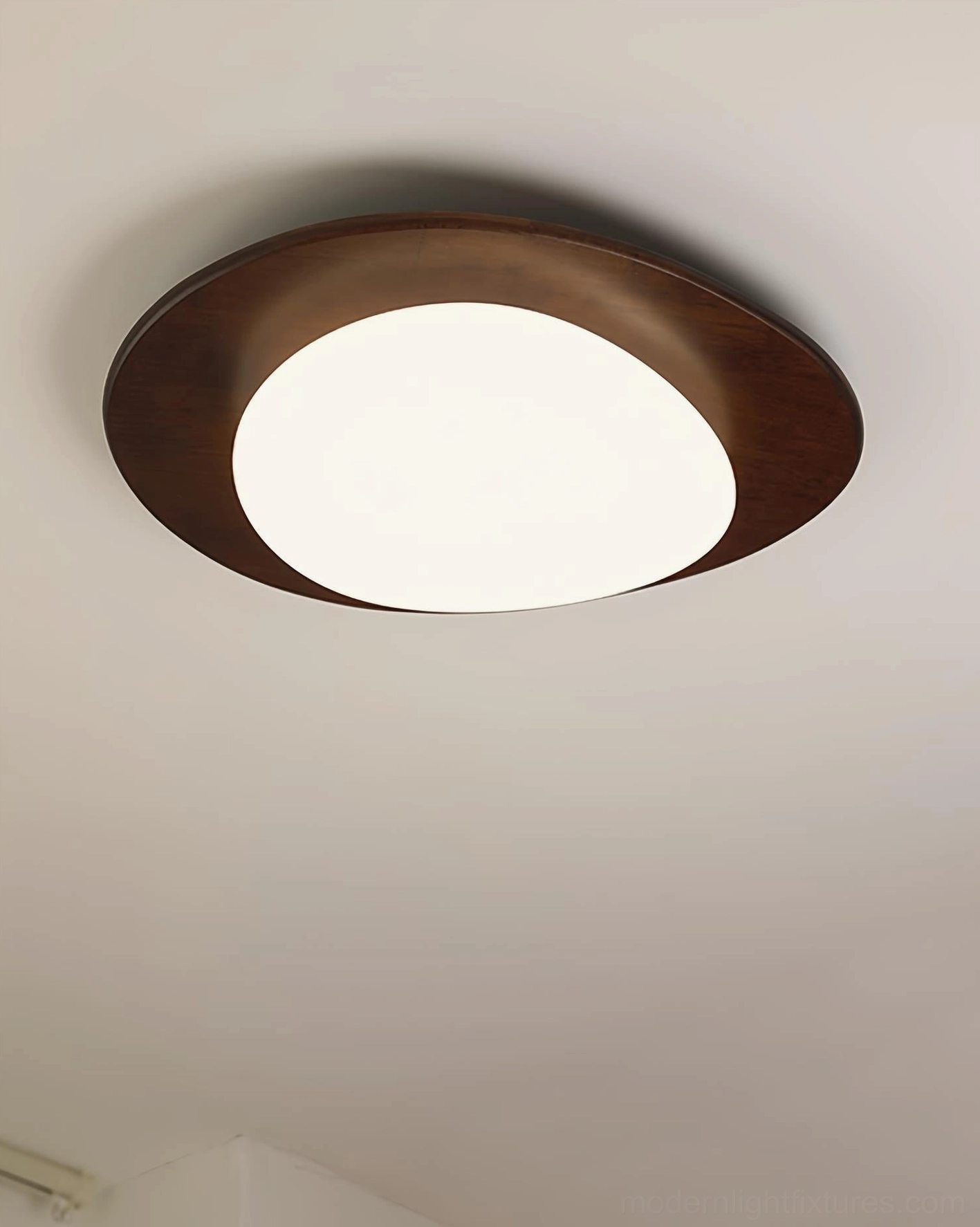 Niseko oval LED ceiling light fixture fully closed design with matching dark wood trim and frosted acrylic diffuser