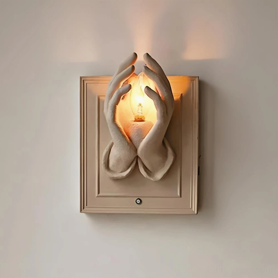 Black hardwired wall sconce with artistic praying hands motif and atmospheric ambient light
