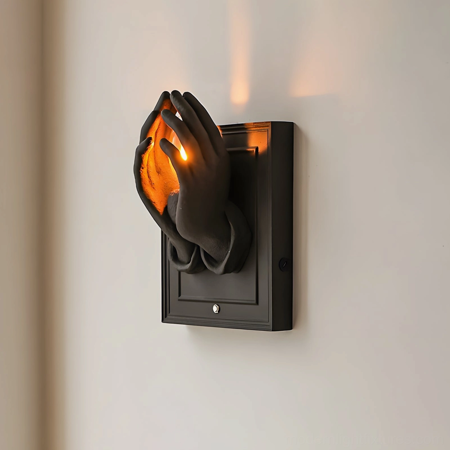 Noctara wall-mounted sconce with black hands cradling warm light in minimalist modern interior