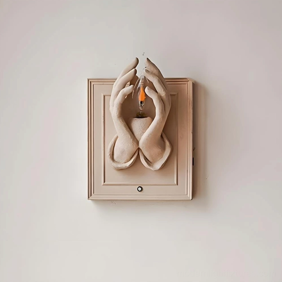 Sculptural wall lighting featuring hand-modeled resin hands form with contemporary aesthetic
