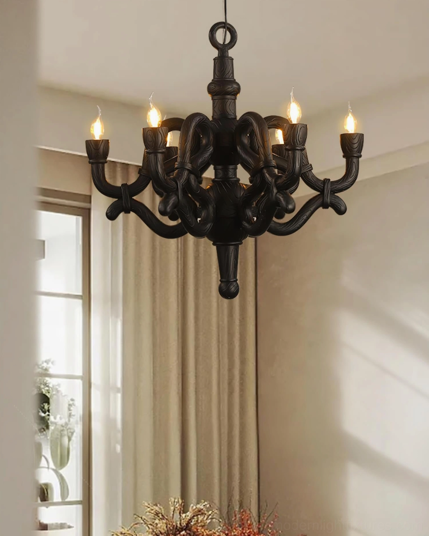 Black sculptural knotted chandelier overhead view warm lighting modern baroque fixture living room