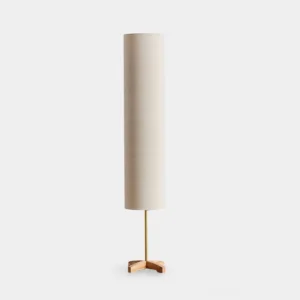 Nomi minimalist floor lamp with beige cylindrical shade and natural wood tripod base against white studio background