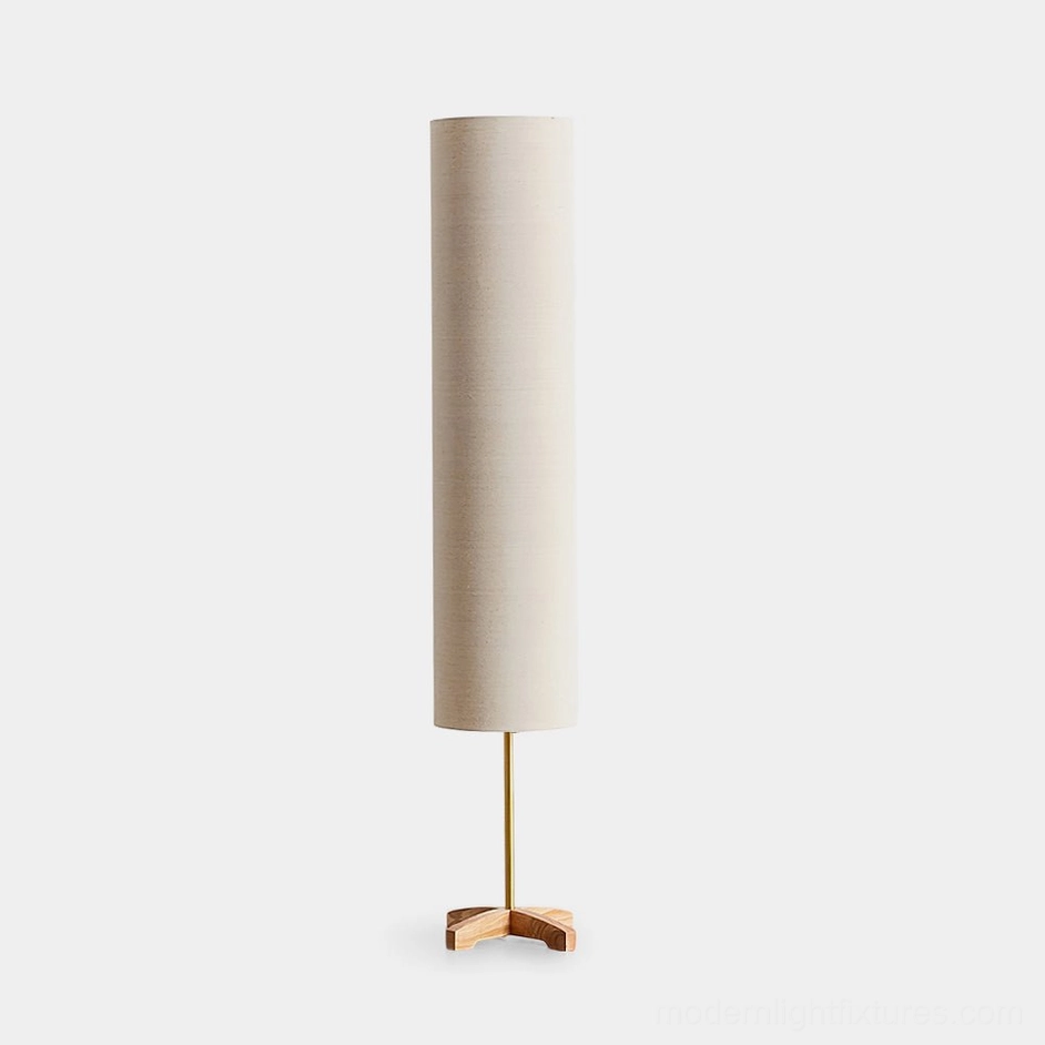 Nomi minimalist floor lamp with beige cylindrical shade and natural wood tripod base against white studio background