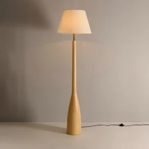 Nora wood floor lamp lit in modern minimalist bedroom with warm ambient lighting