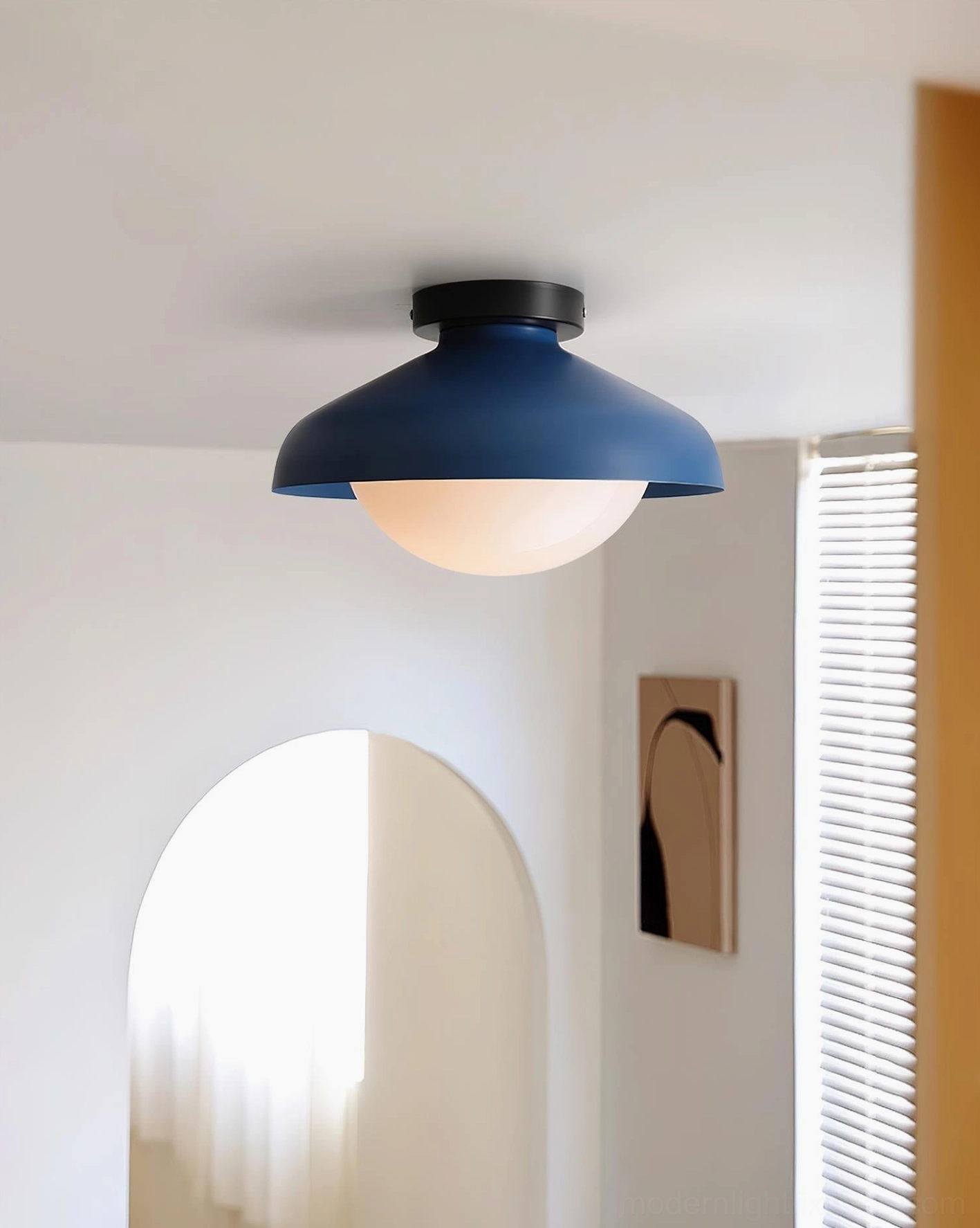 Nordic minimalist semi-flush ceiling lamp with navy blue dome and black mounting base, side perspective in modern apartment