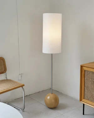 Nordic floor lamp with wooden base and metal pole illuminated in modern dining nook, interior design photo