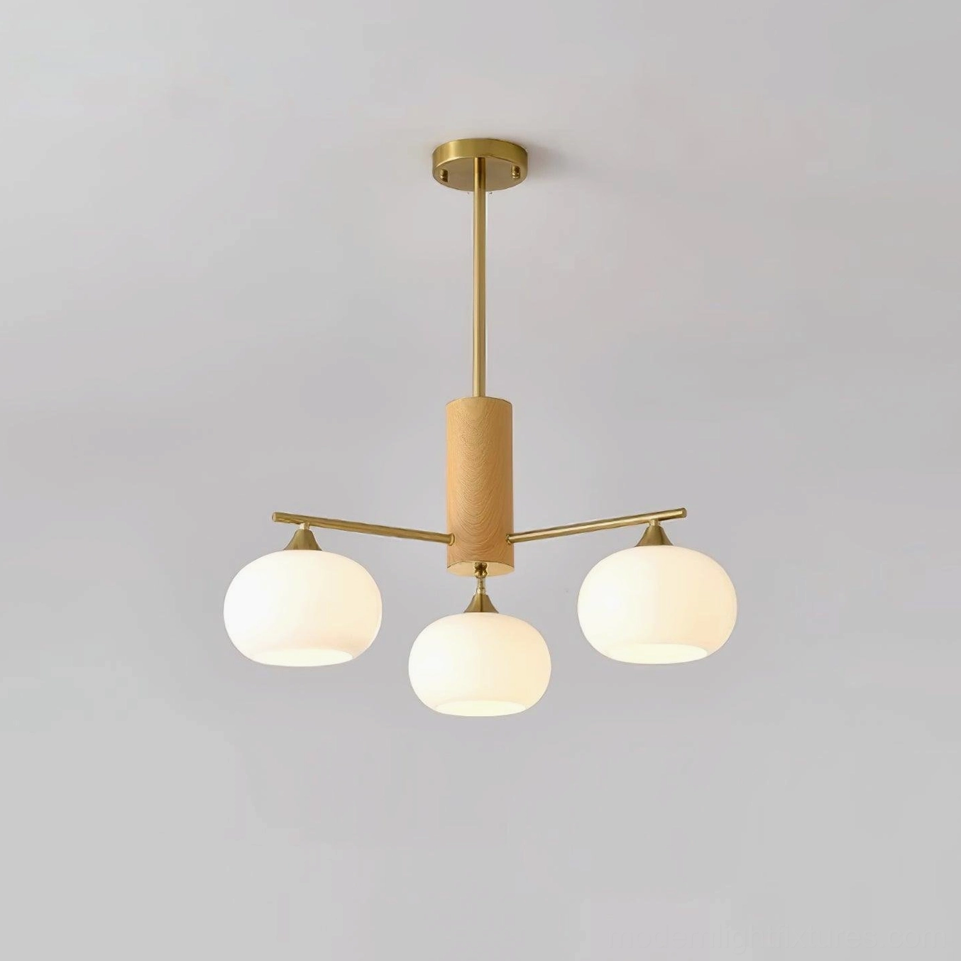 Nordic glass chandelier with brass finish and white opal globes soft ambient lighting design