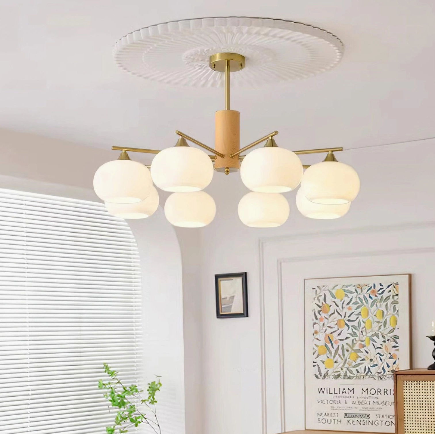 Nordic style multi-head pendant chandelier with brass wood frame glowing in minimalist living room