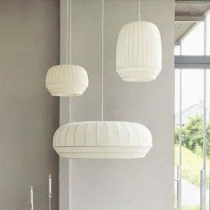 Nordic pendant lights in modern living room corner - multiple fabric hanging lamps interior design