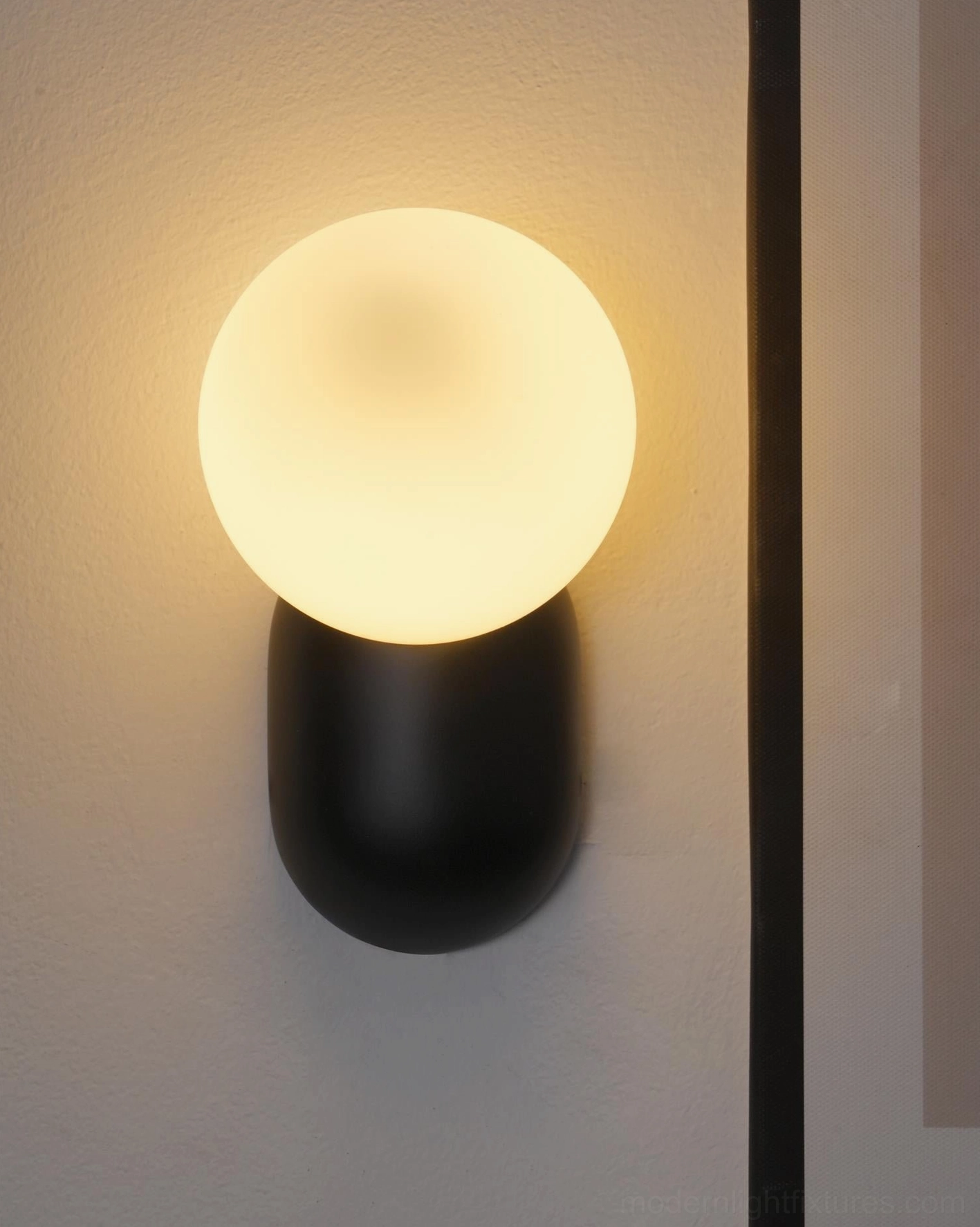 Nordic minimalist spherical wall sconce with matte finish and modern architectural proportions