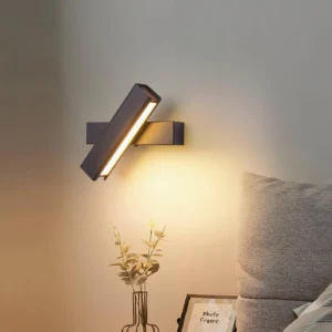 Adjustable Nordic wall lamp mounted on bedroom accent wall, eye-level side view with warm ambient lighting