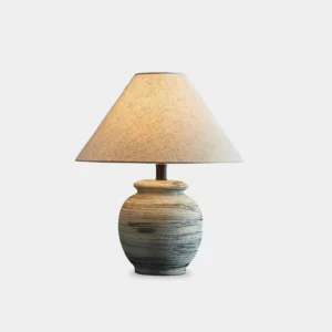 Norma ceramic table lamp with grey and white striped base and tapered linen shade, front view on white background