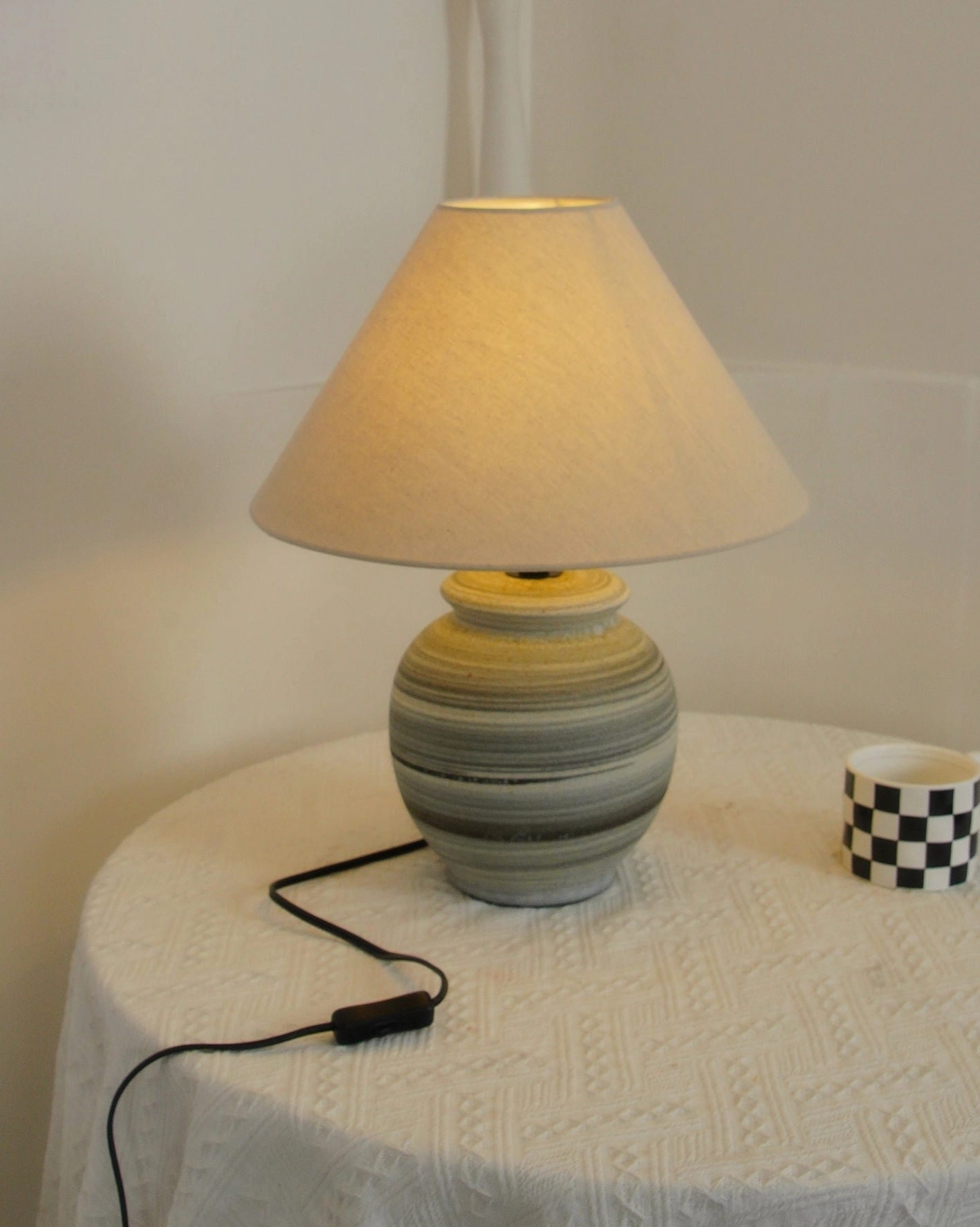 Norma table lamp creating layered lighting in contemporary living room with mixed material styling