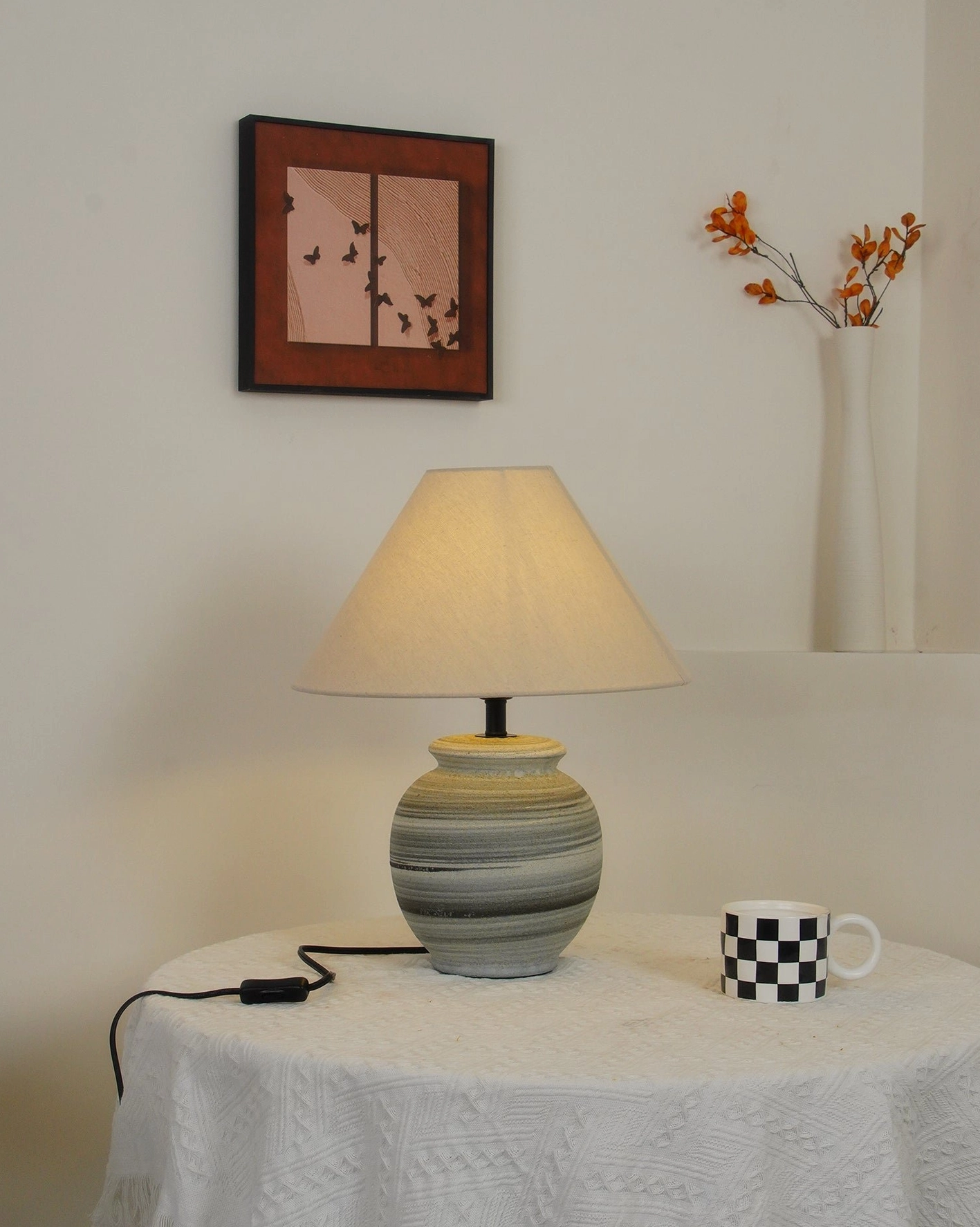 Norma ceramic table lamp illuminating dining area with scandinavian furniture and neutral palette