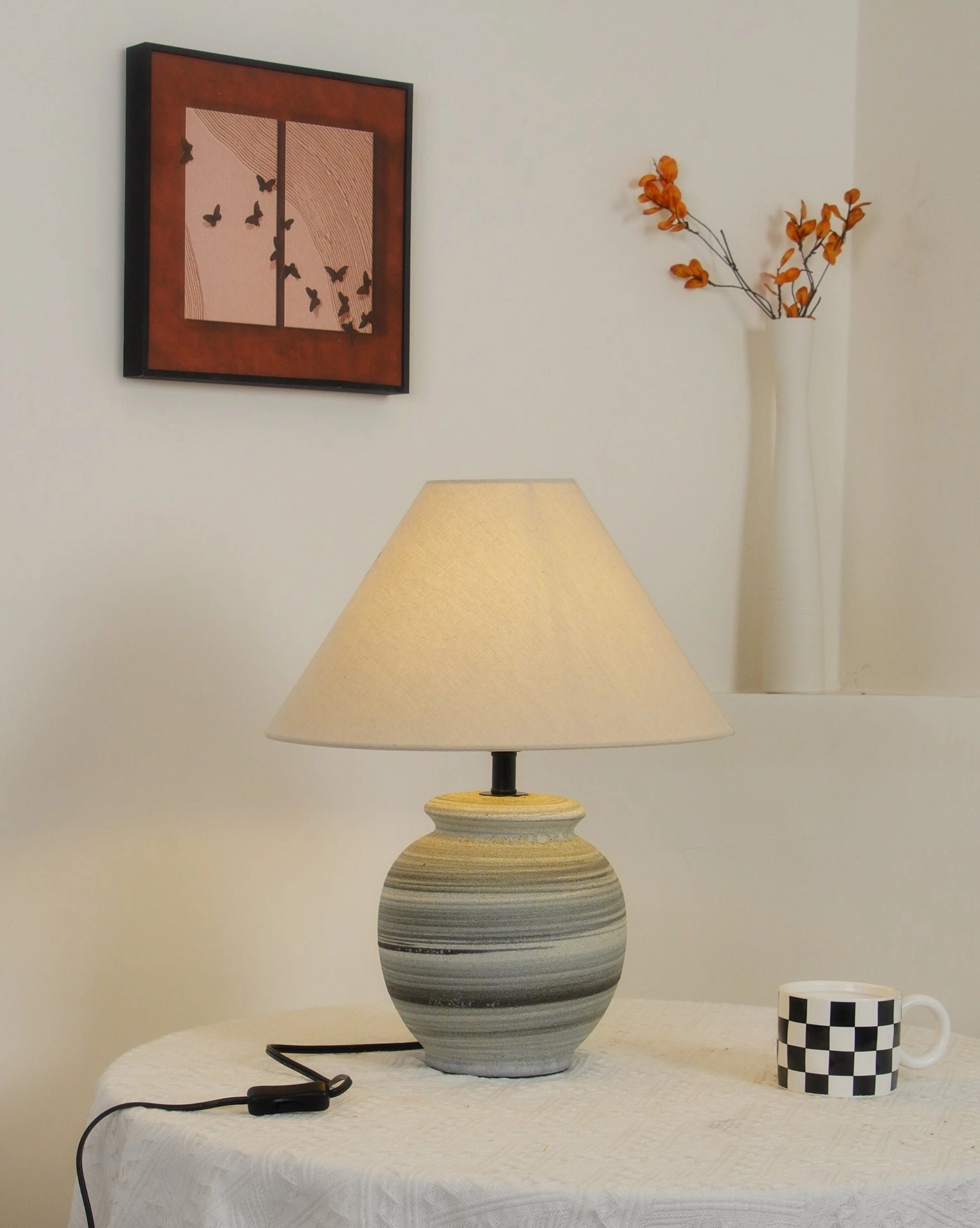 Norma table lamp in industrial minimalist space with concrete elements and natural wooden accents