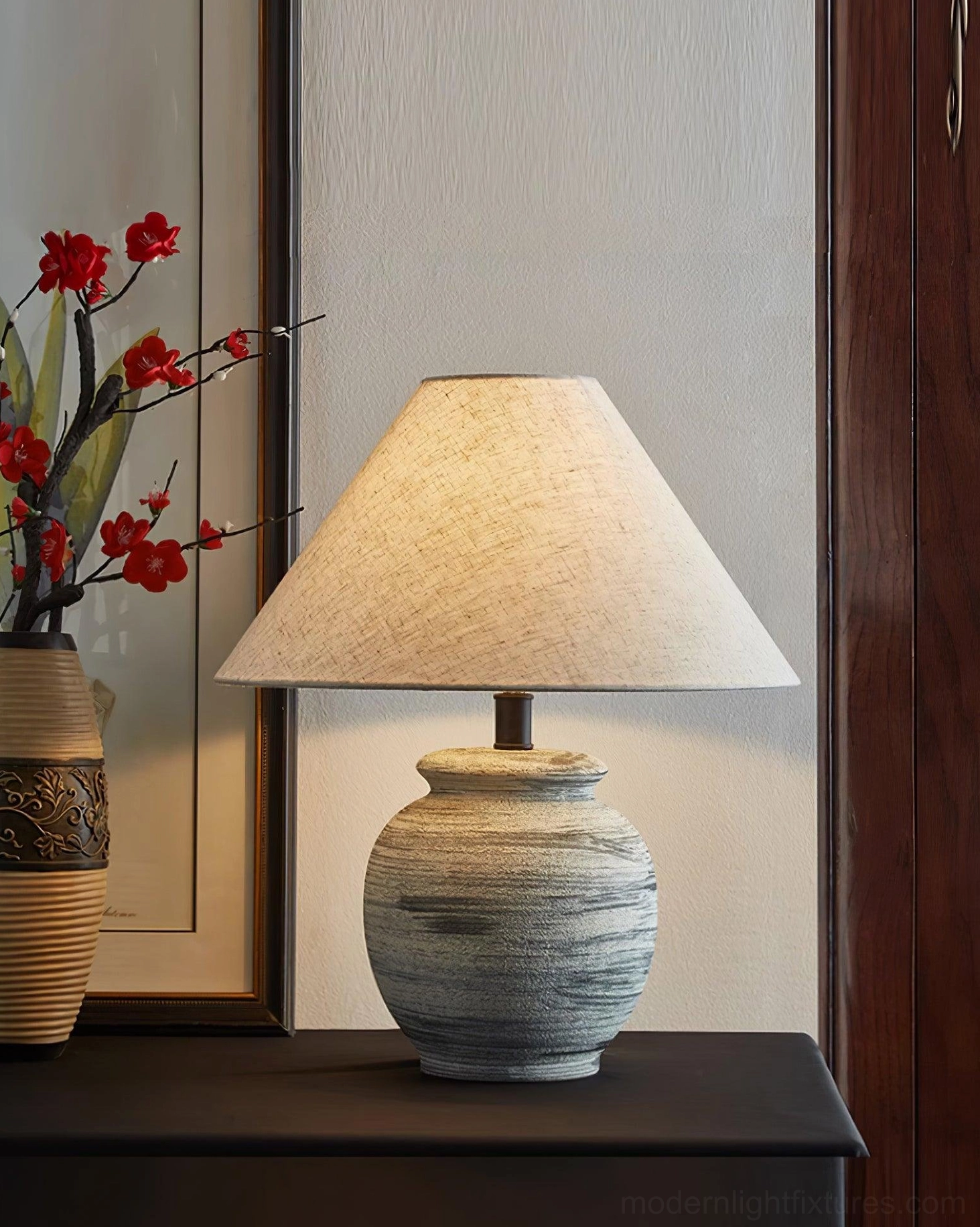 Norma table lamp creating warm ambient lighting in scandinavian design living space with wooden furniture