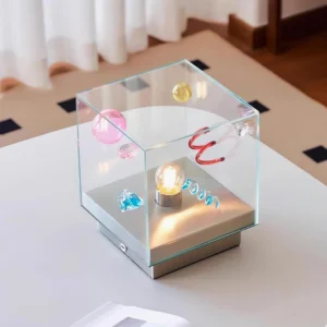Nova Box Cube Table Lamp side view showing transparent glass enclosure with warm central glow