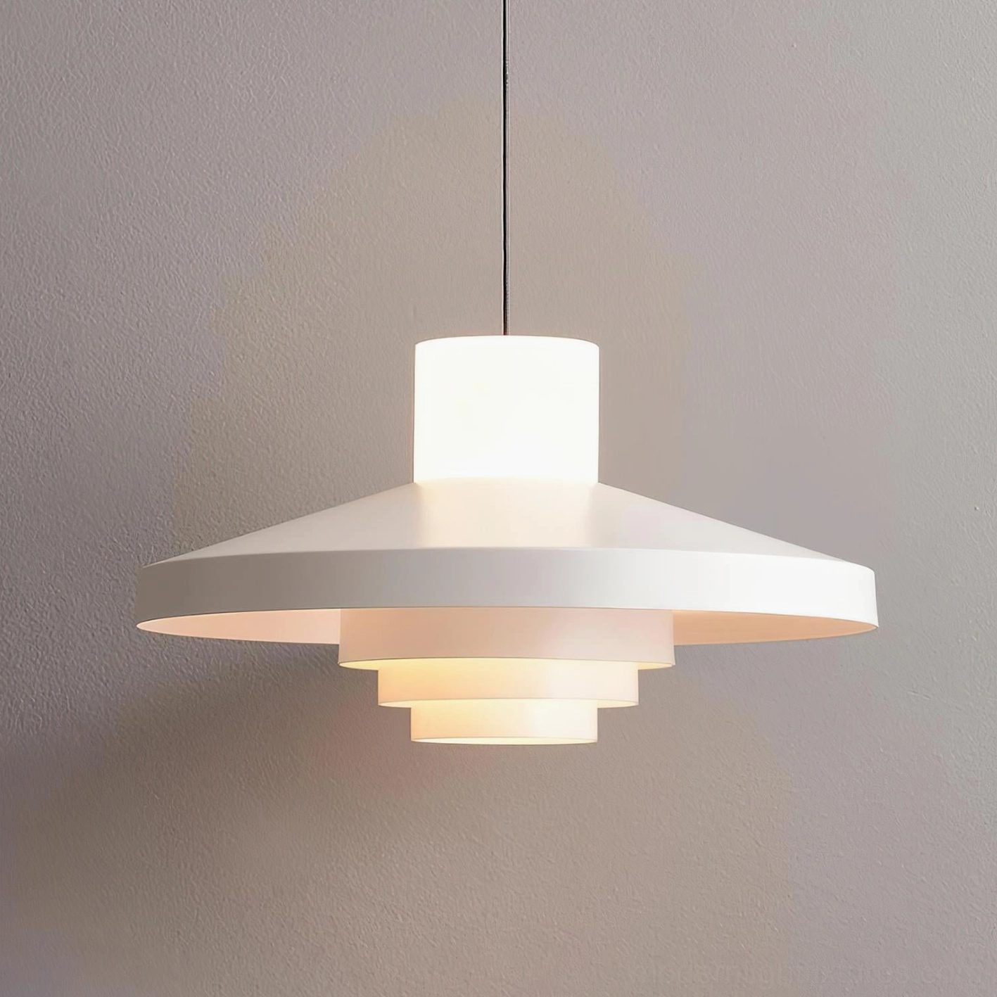 Nova Cap geometric pendant light in white color variant showing tiered disc shade against ceiling installation
