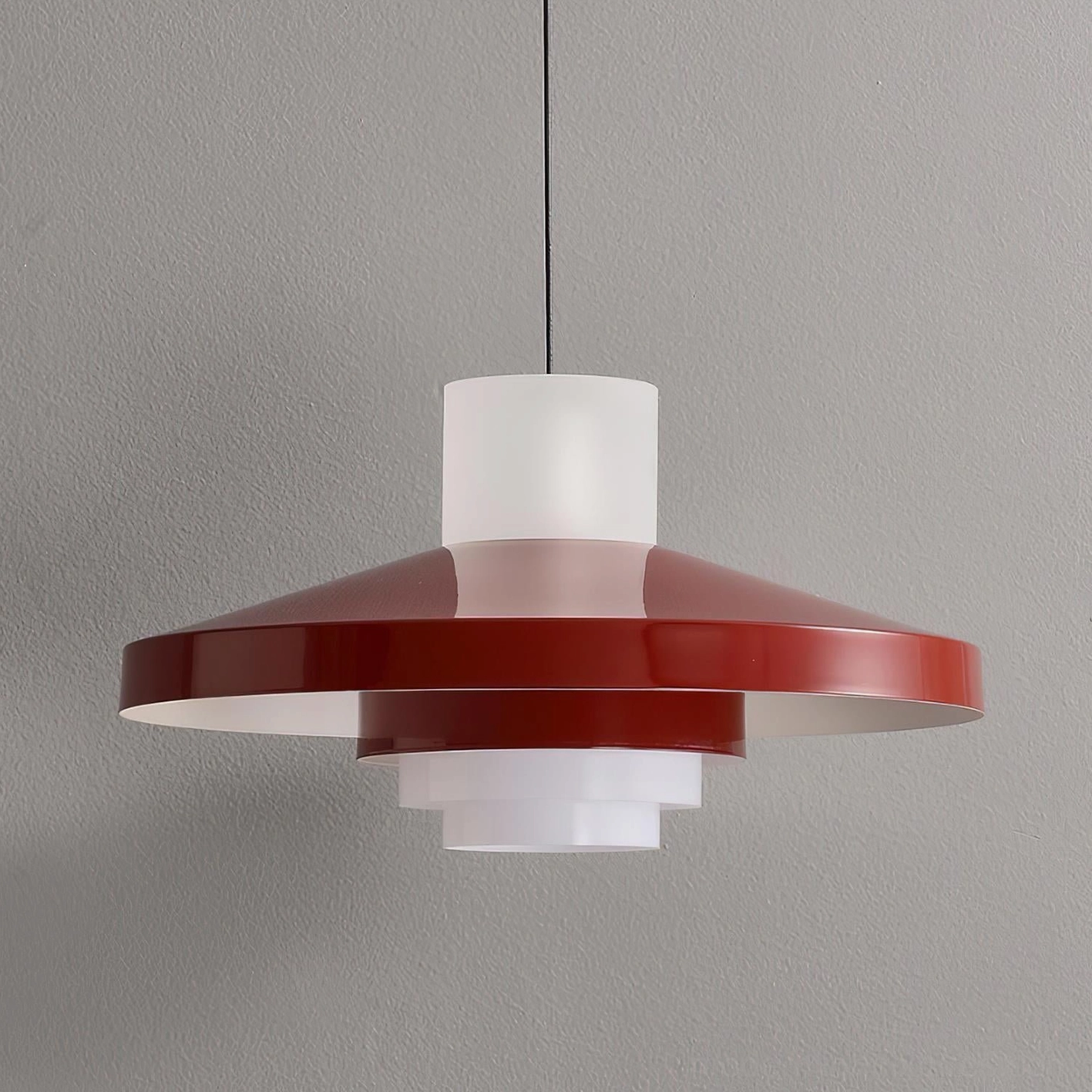 Nova Cap geometric pendant light with wine red shade suspended above round dining table in vintage style room