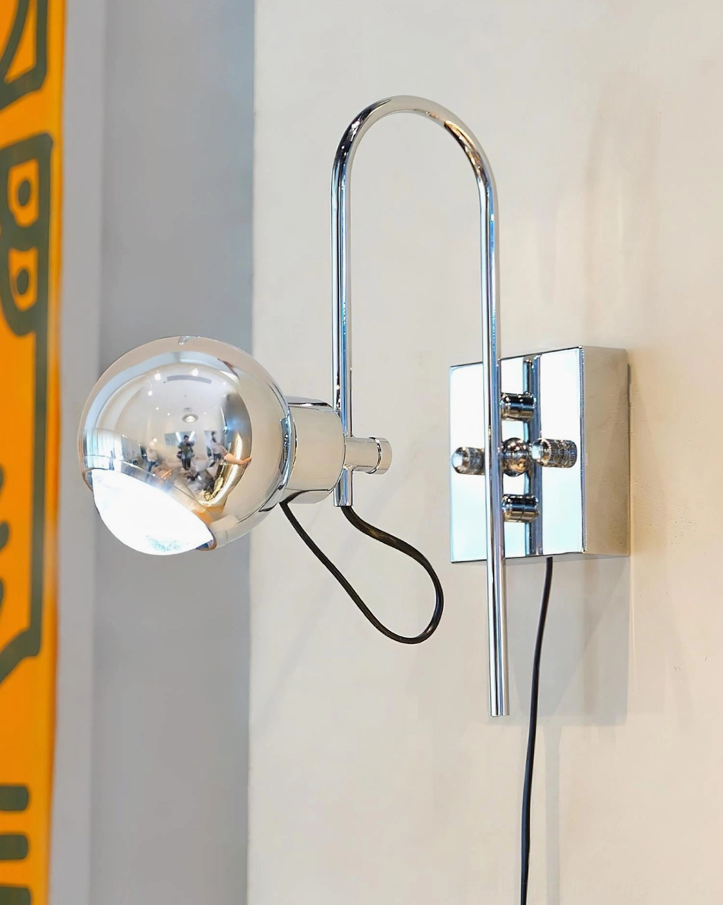 Nova Dot chrome wall sconce with clear spherical shade and square chrome wall mount, right front side view