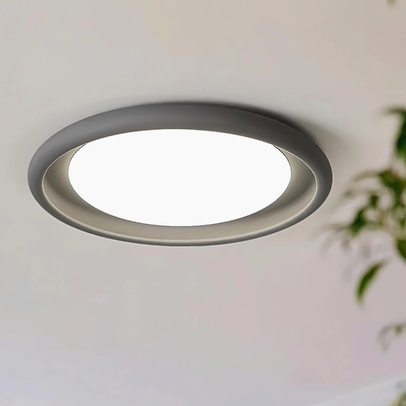 Contemporary minimalist ceiling light with matte finish, overhead architectural detail of circular design