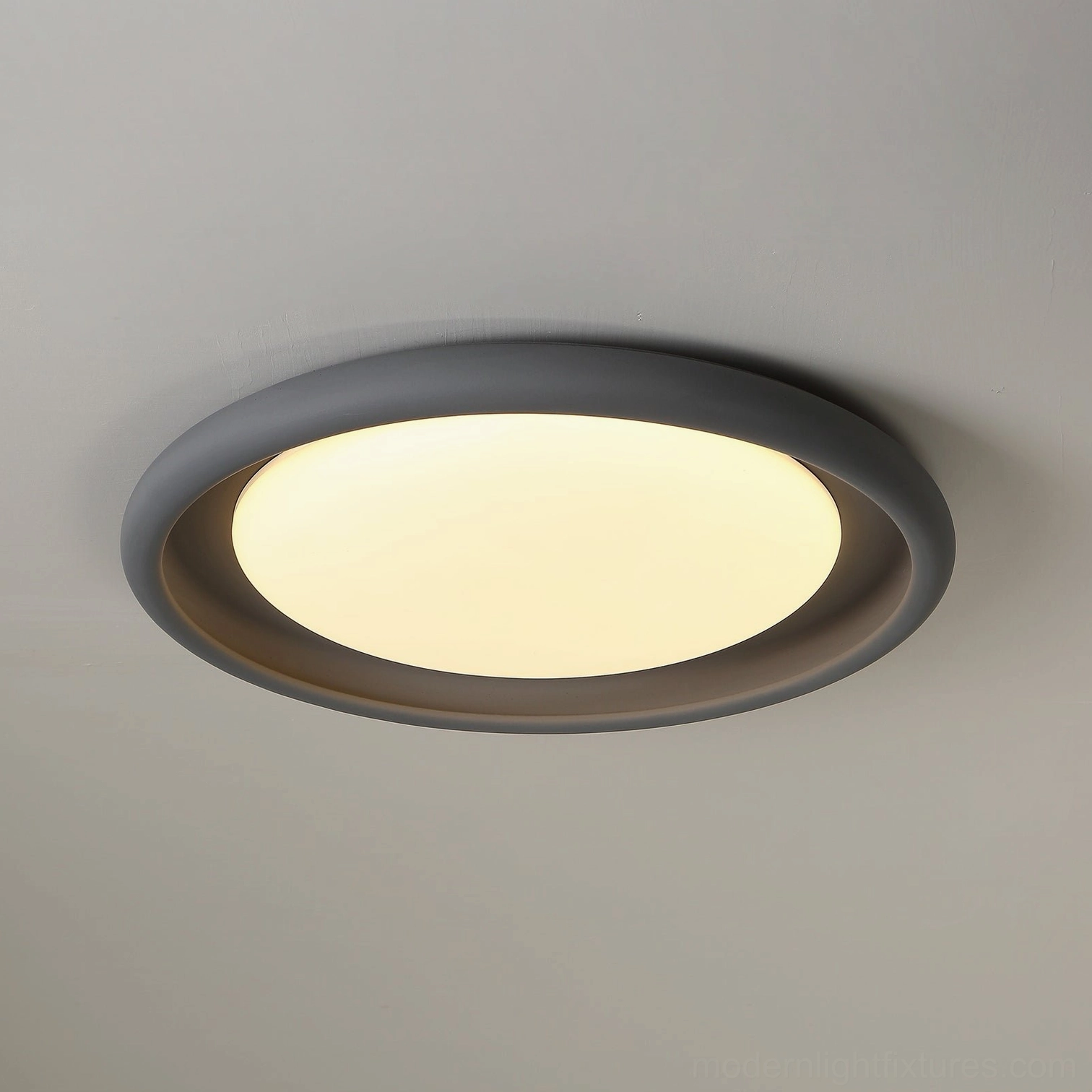 Dark gray minimalist flush-mount ceiling light, close-up low-angle overhead view of matte frame