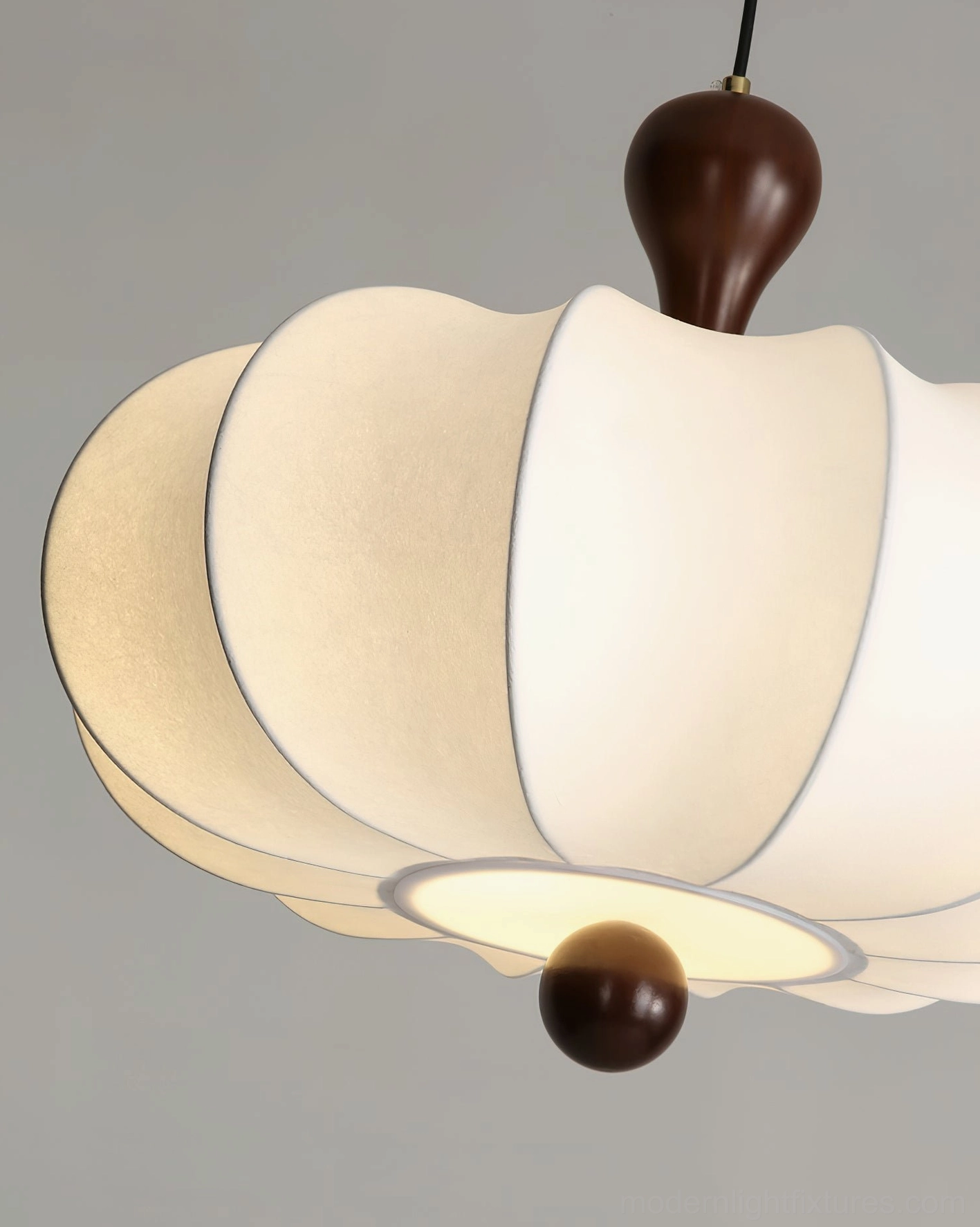 Nutria pendant lamp showing fabric ribs and light distribution pattern