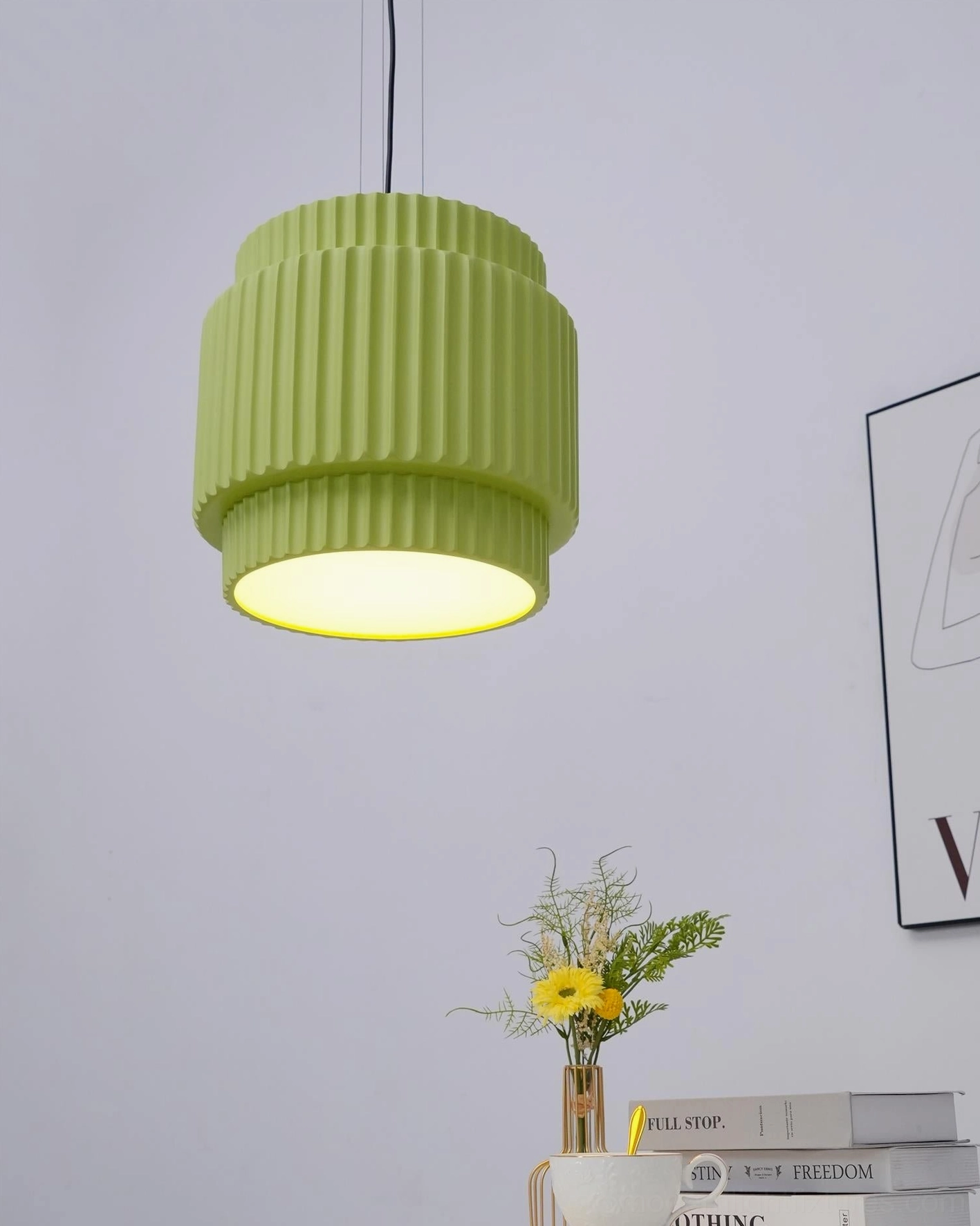 Illuminated sage green Nyla ribbed pendant light, low angle glow, minimalist home table setting