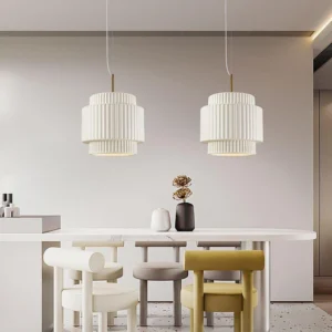 Pair of white tiered pendant lights in modern dining room, overhead view, minimalist neutral decor