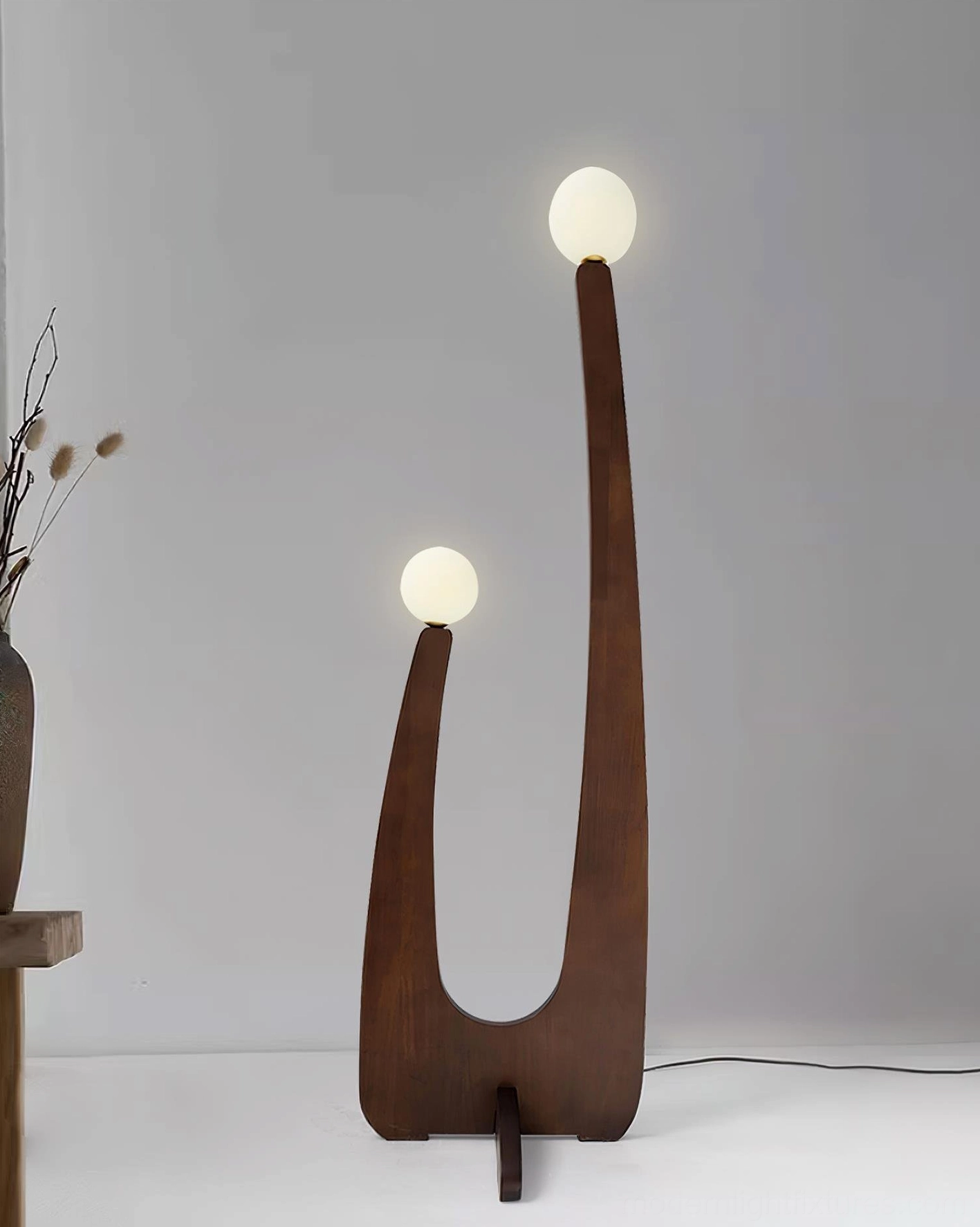 Handcrafted wooden floor lamp with two frosted glass diffuser shades in bright studio environment