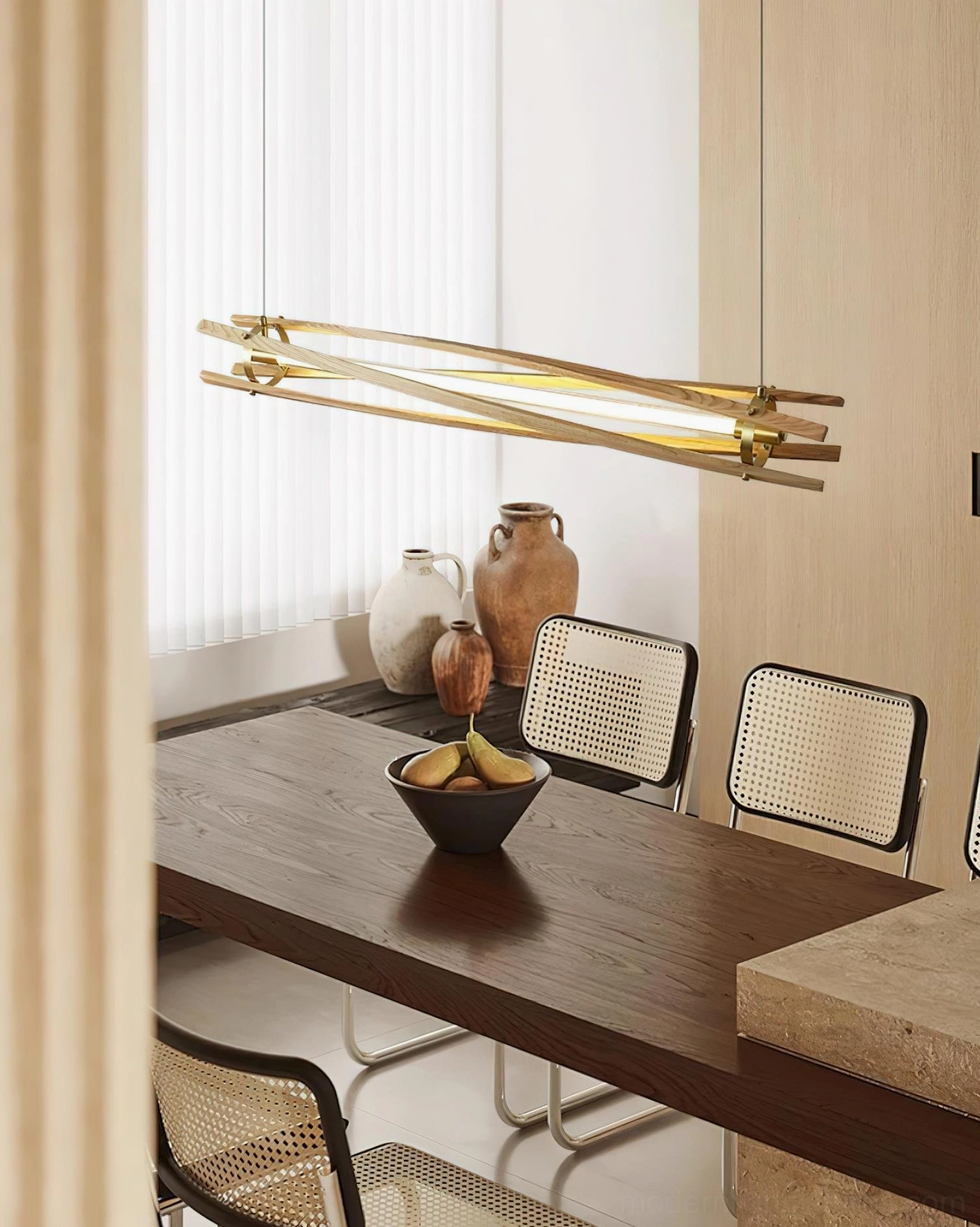 Light oak linear wood pendant lamp illuminating kitchen island with wooden countertop in warm minimalist kitchen
