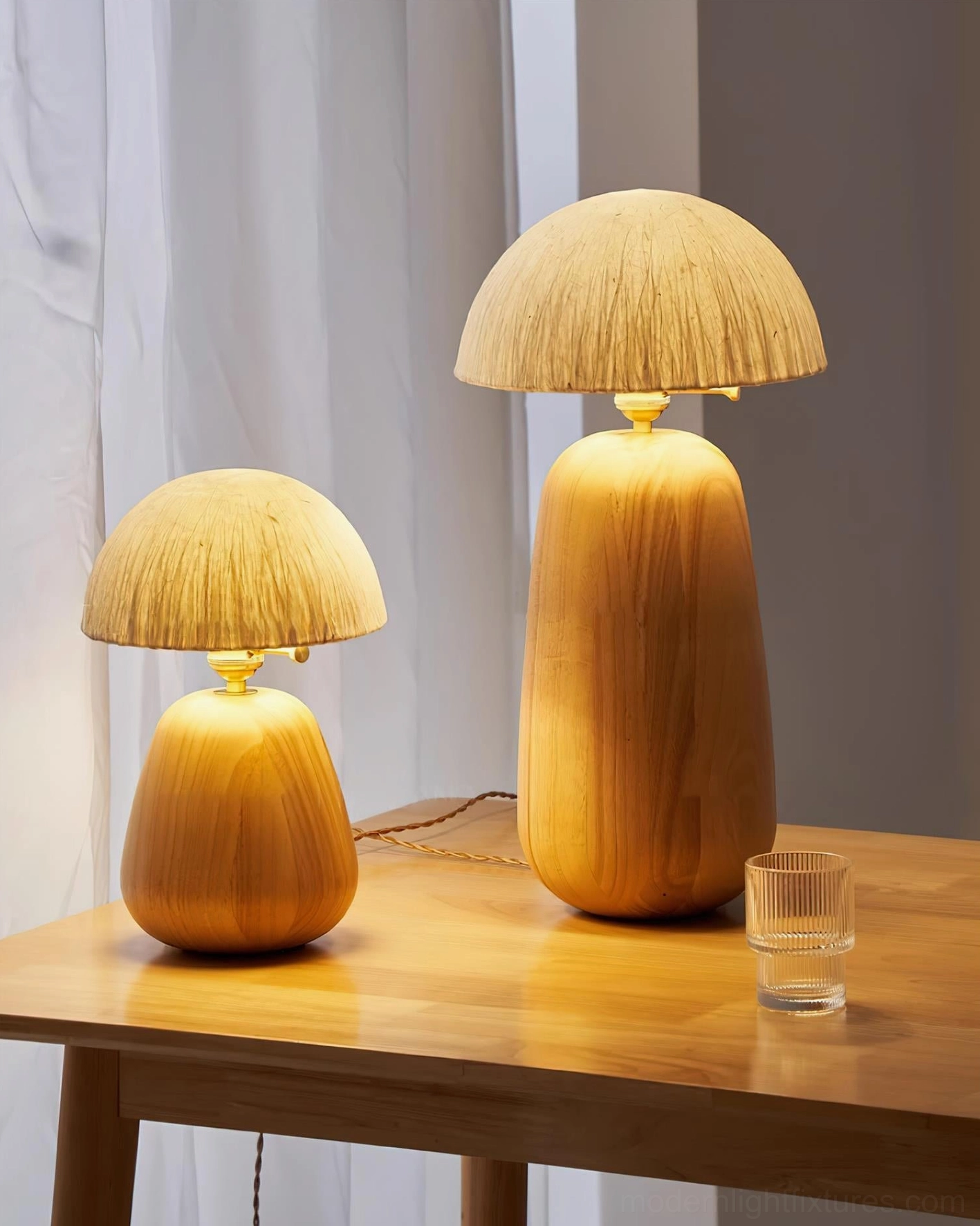 Oak wood table lamp with adjustable metal switch detail and warm ambient lighting in home interior