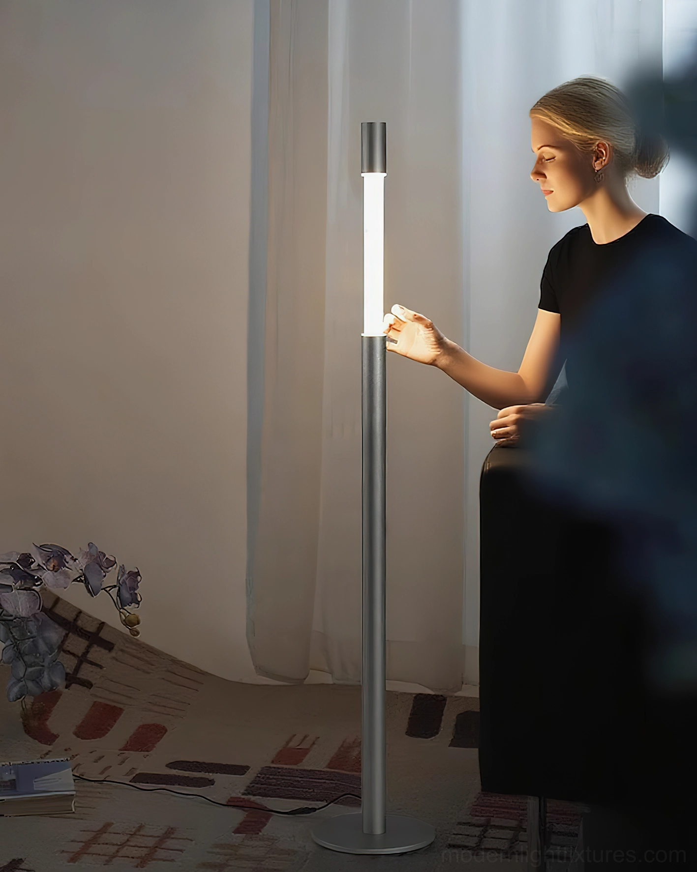 Obelisk floor lamp in brushed silver with touch operation in cozy residential setting