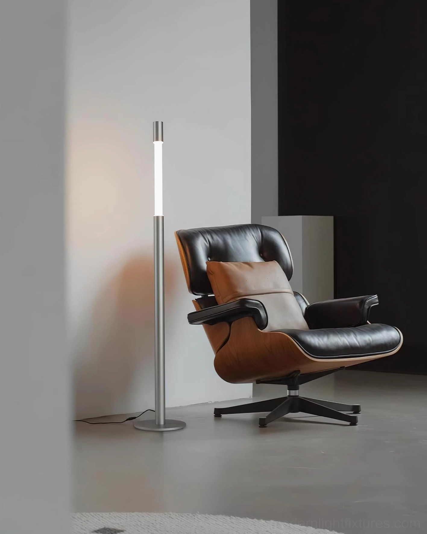 Obelisk minimalist floor lamp side angle with warm LED illumination near mid-century lounge chair