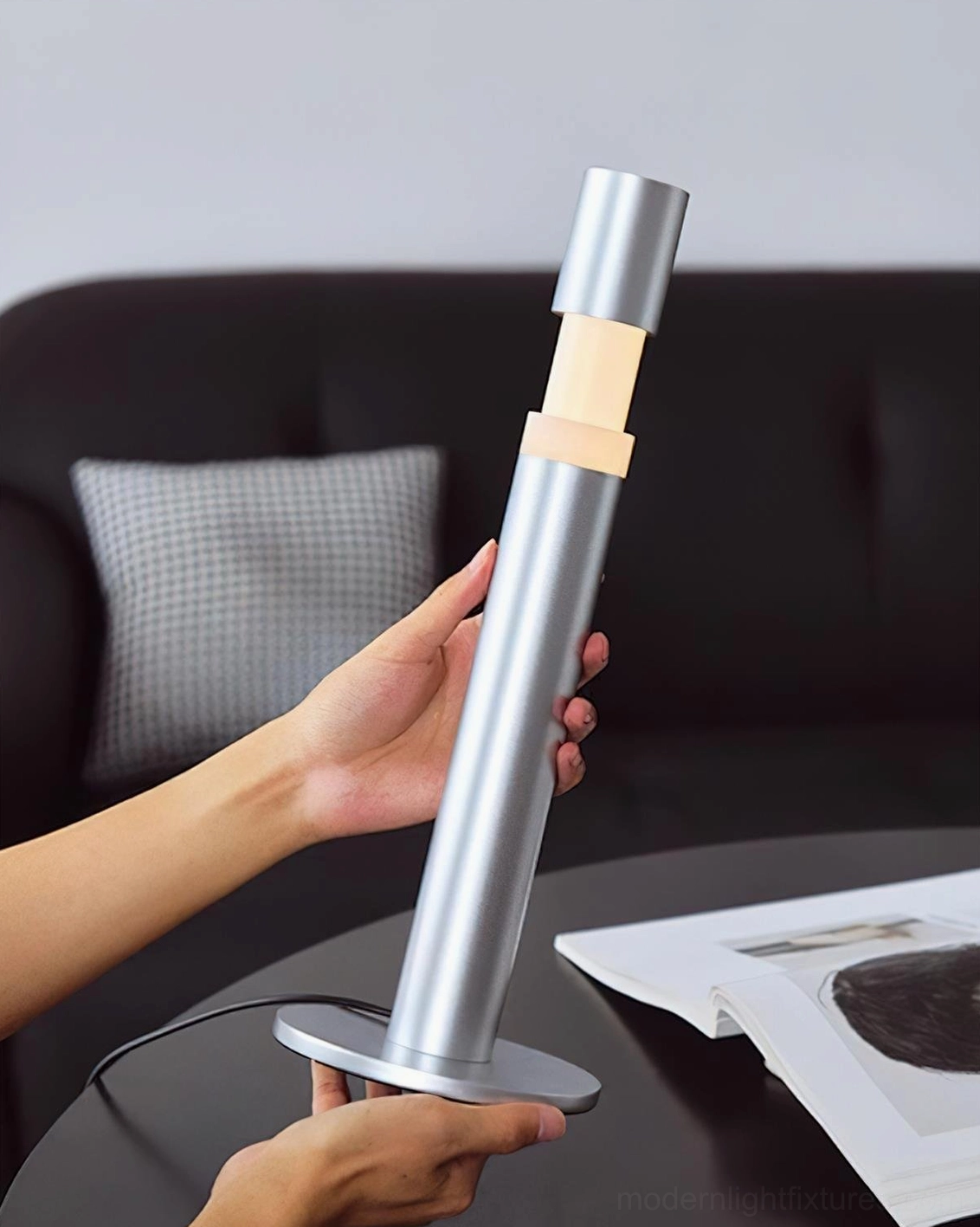 Obelisk modern cylinder table lamp portable aluminum construction held in hands