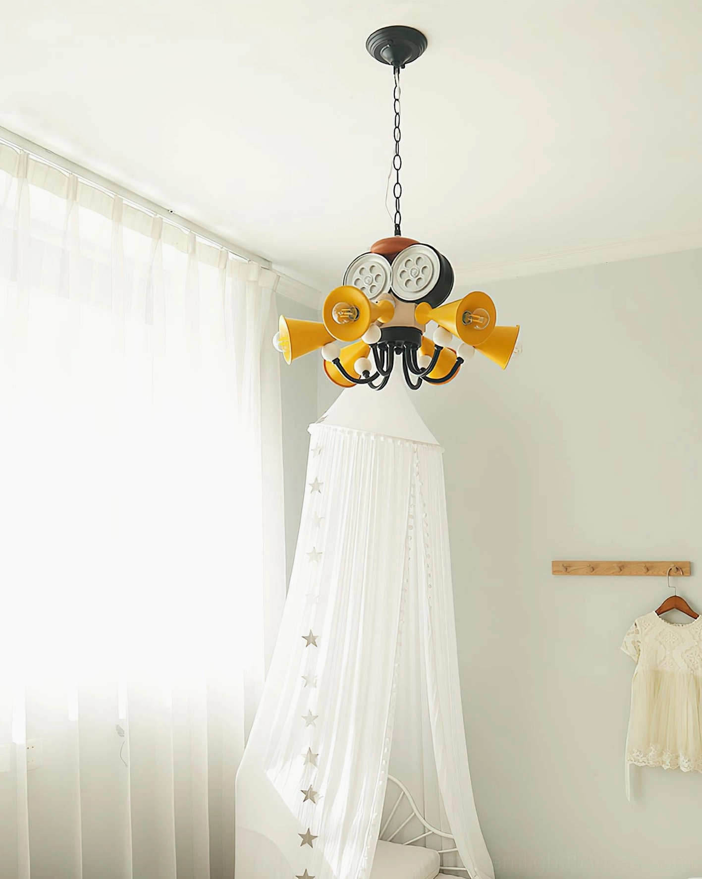 Full room view of octopus director chandelier in children's bedroom with white tent and wall storage decor