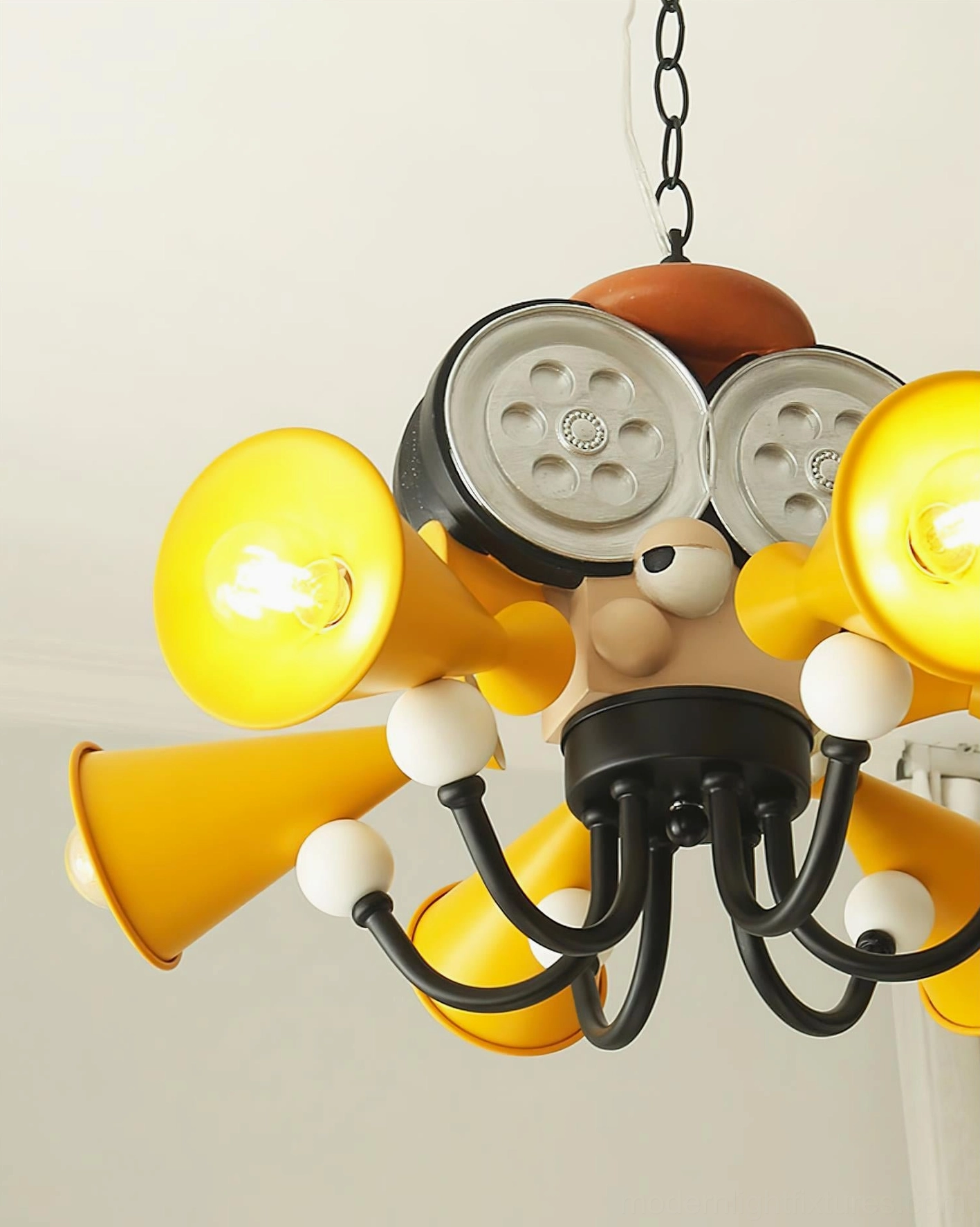 Close-up detail of octopus director chandelier showing exposed bulbs and white decorative accent elements