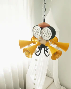 Whimsical octopus chandelier in children's bedroom with sheer curtains, showing tapered yellow spotlight cone arms