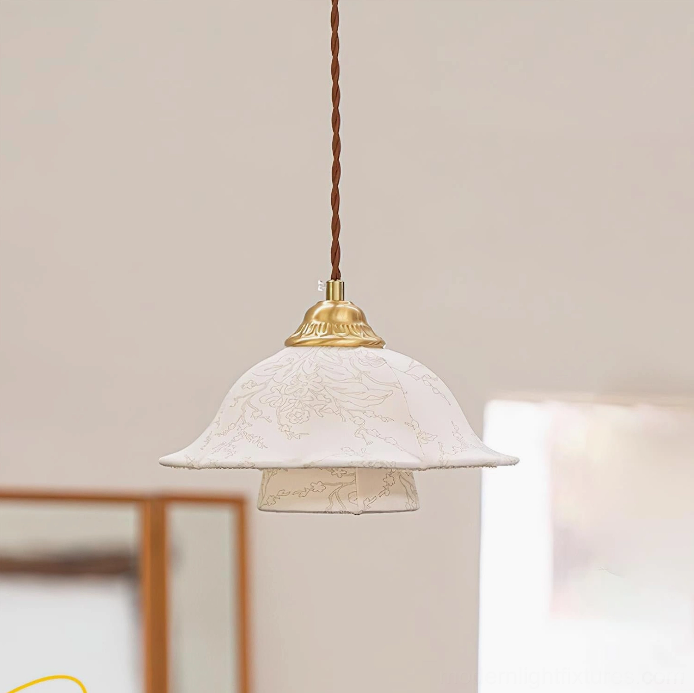 Off-white floral fabric pendant shade with brass hardware and twisted cord detail view
