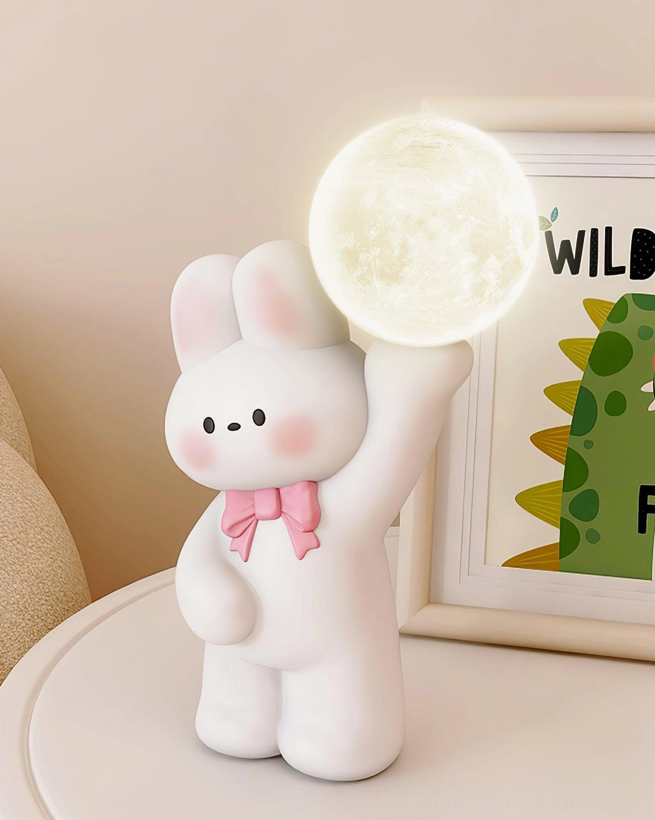 Off-white rabbit moon lamp with pink bow tie glowing on side table - contemporary character lamp